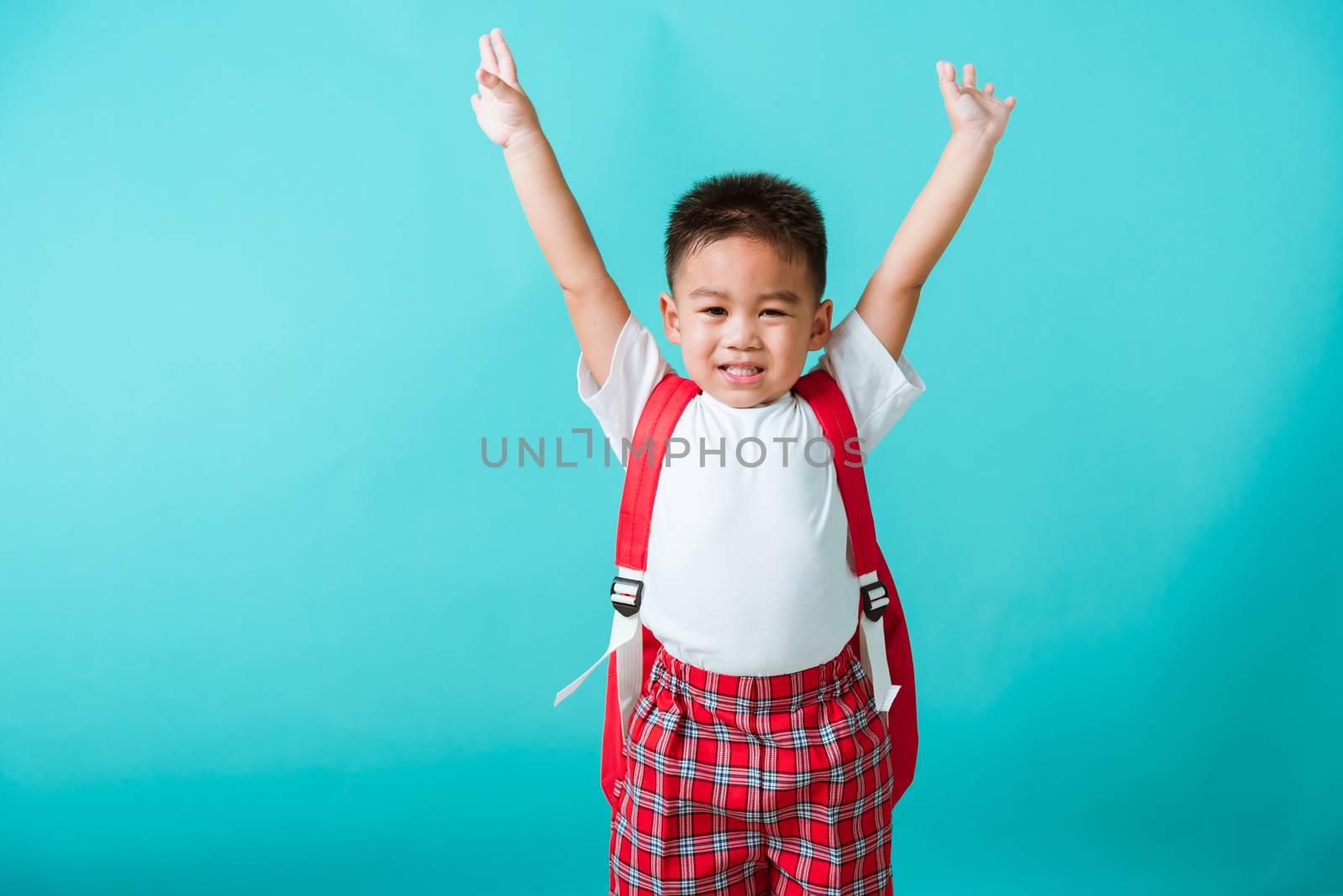 child boy in uniform smile raise hands up glad when go back to s by Sorapop