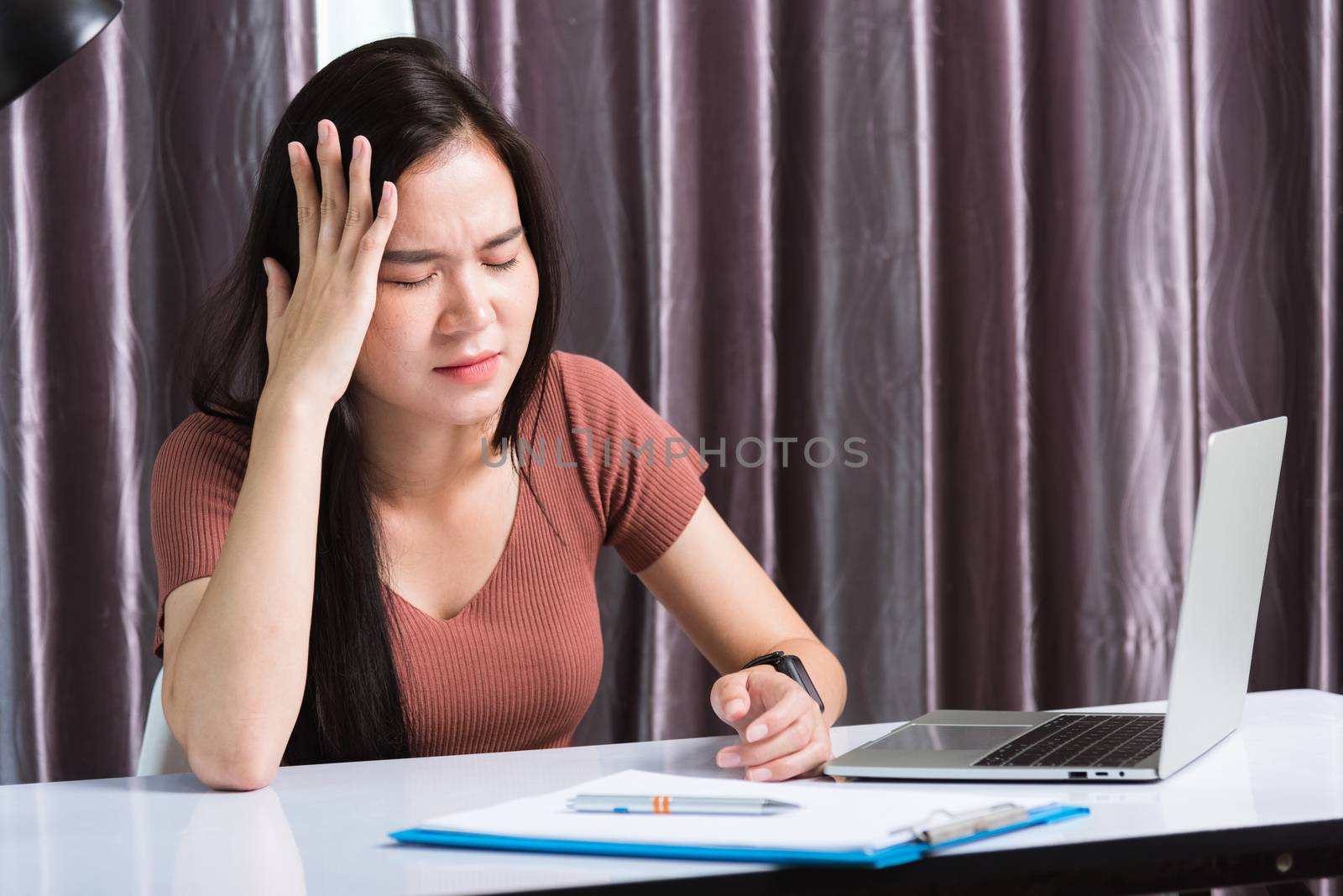 Work from home, Fatigued or strain Asian business young beautiful woman sitting on desk workspace feeling tired stressed hand hold head after long sedentary laptop computer technology at home office