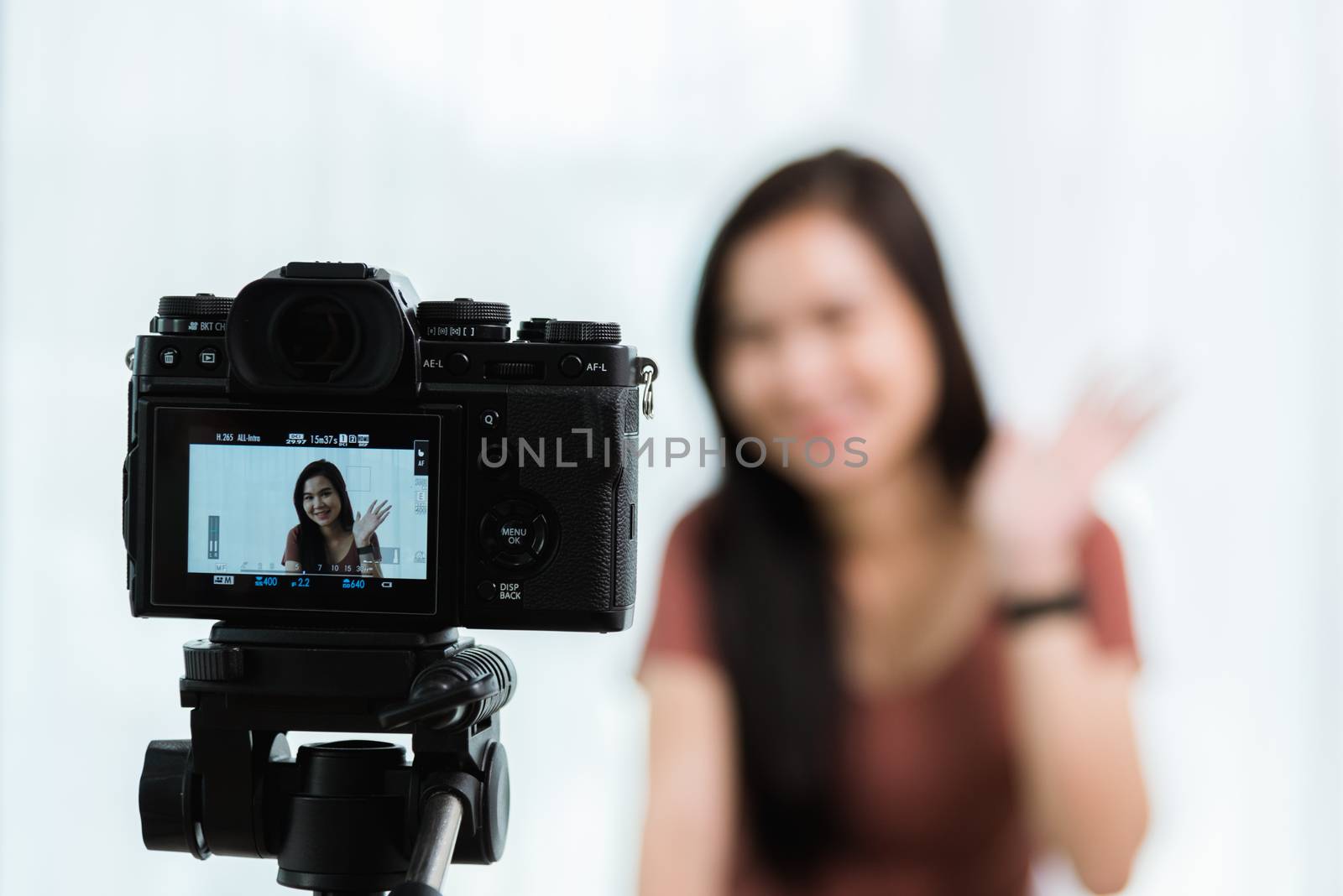 Work from home. Smiling Happy Asian young beautiful woman blogger with professional digital technology equipment live recording talking video call conferencing online videoblog channel