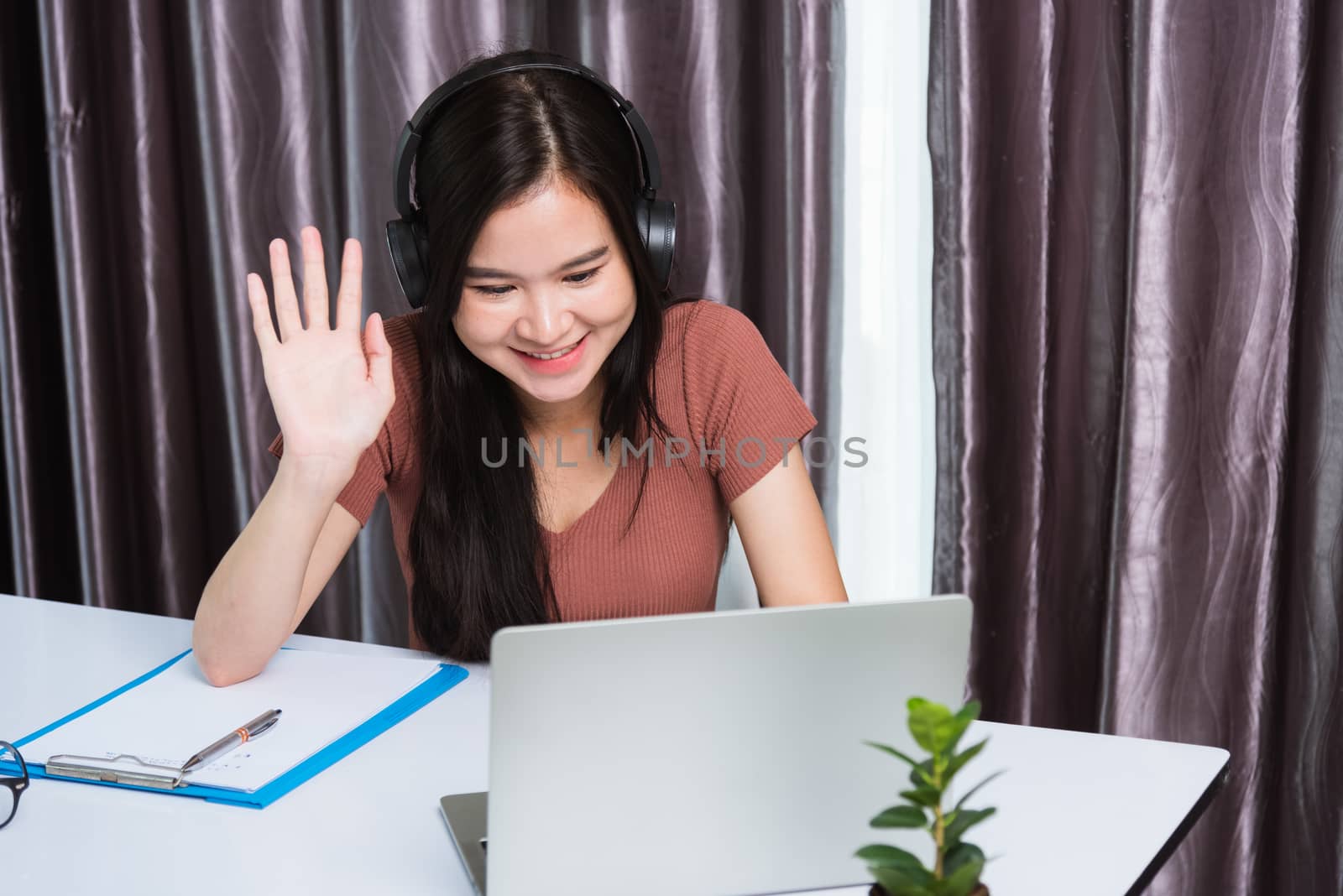 Business woman wearing headphones video call conference by Sorapop