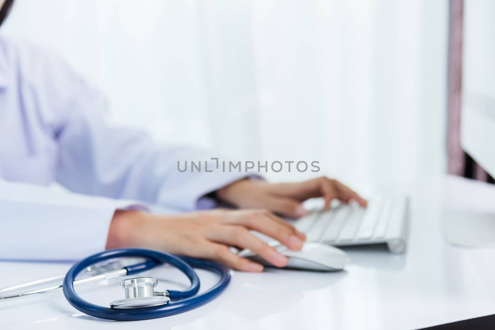 Medicine doctor's working on desk. Closeup of Stethoscope. Hand of woman physician type keyboard to order medicine for patients on table front PC computer at hospital office, Healthcare medic concept