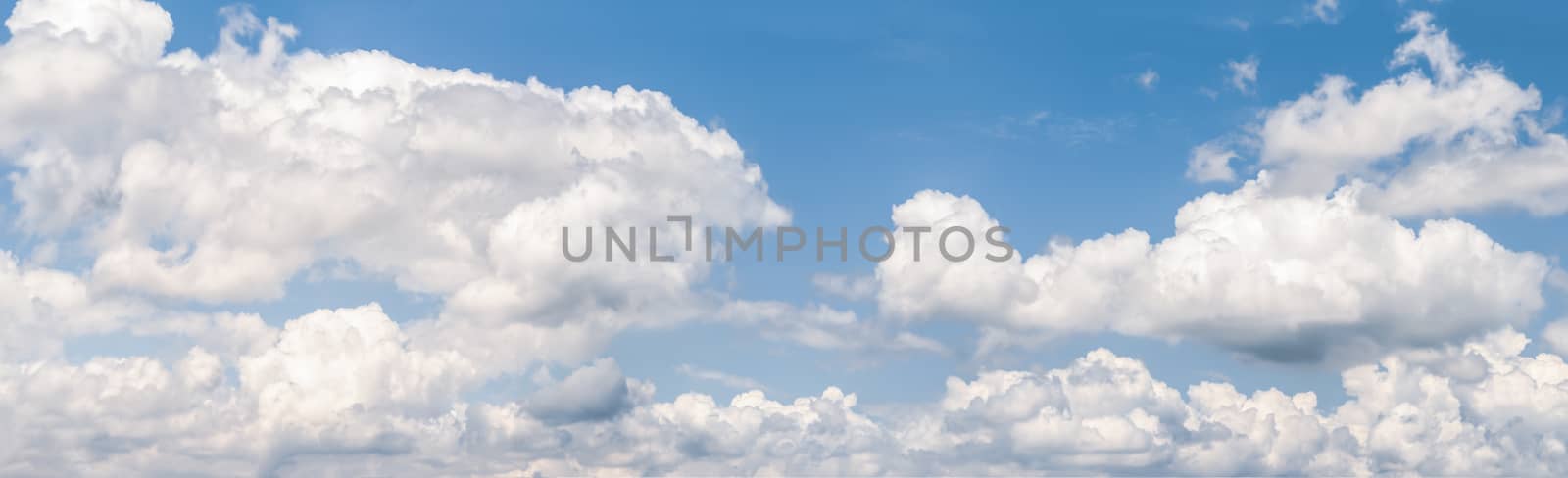 Panoramic white fluffy clouds in the blue sky, Fantastic soft white clouds against blue sky