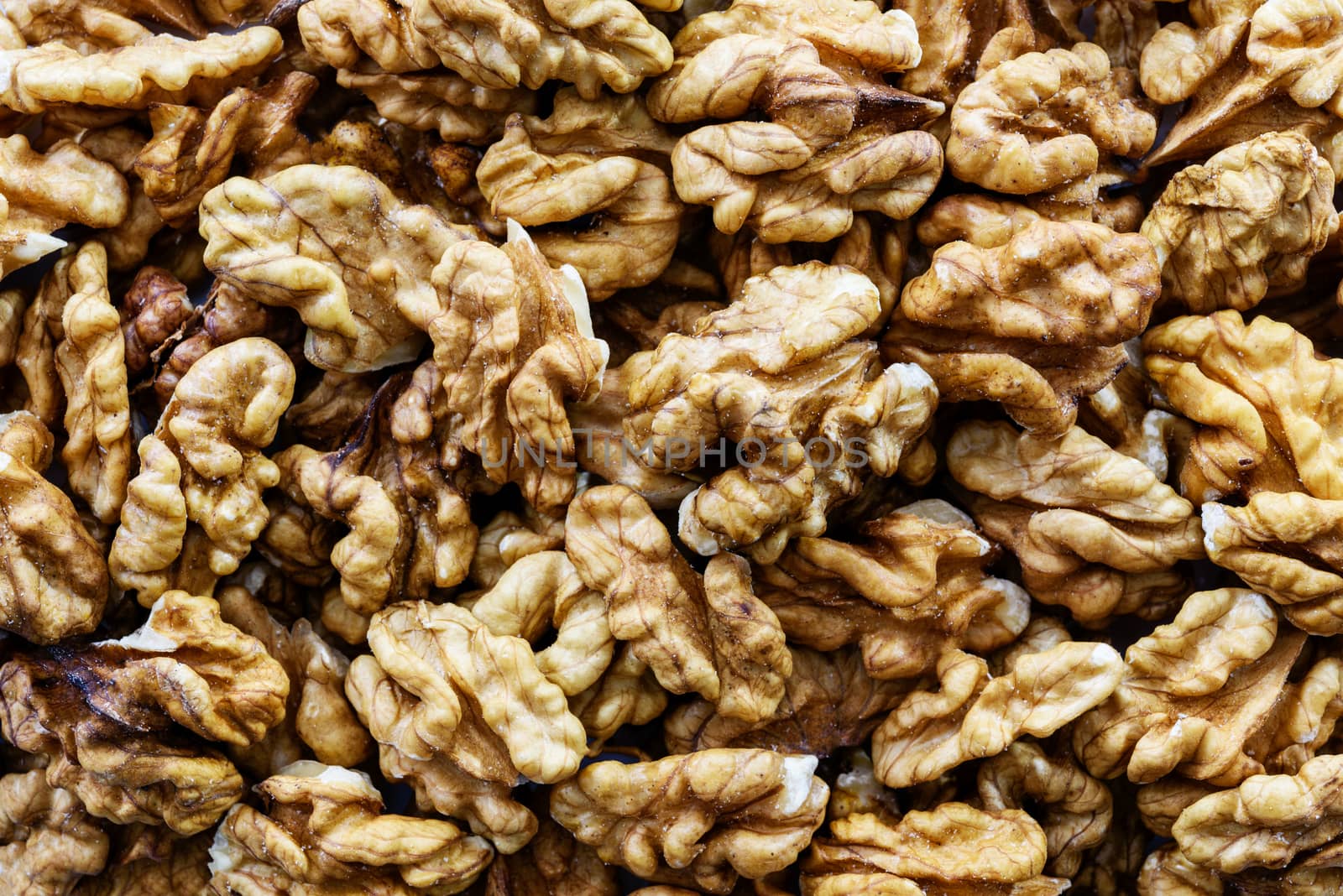 Background of shelled dried walnuts in close-up (high details)