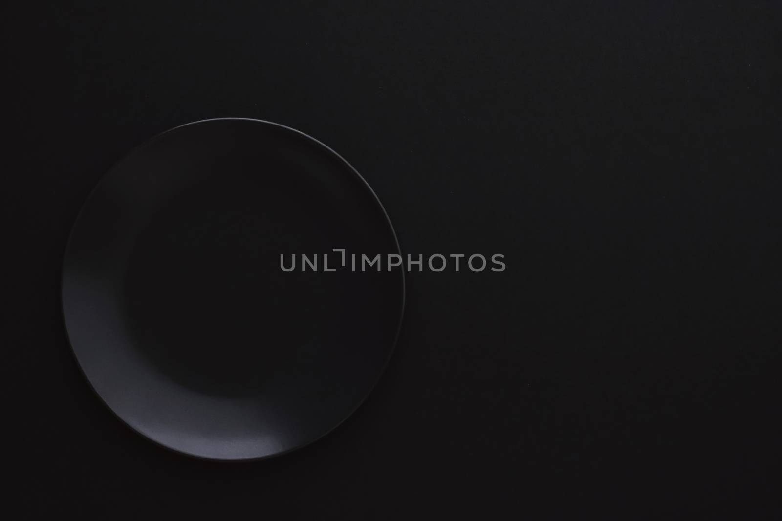 Empty plates on black background, premium dishware for holiday dinner, minimalistic design and diet concept
