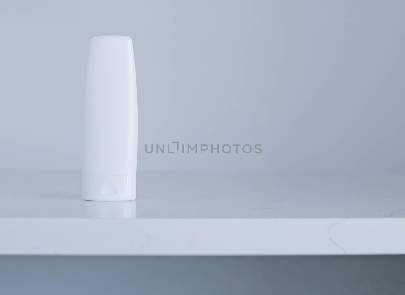 Blank label cosmetic container bottle as product mockup on gray background, hygiene and healthcare