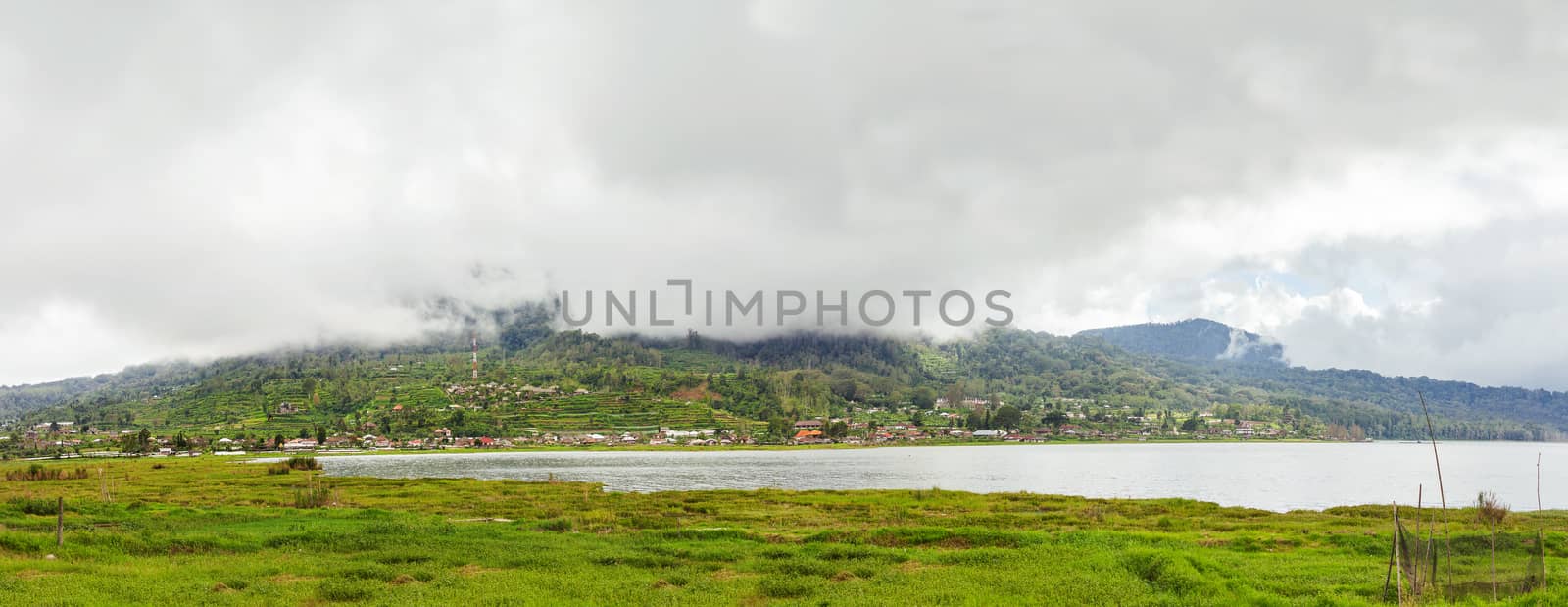 Panorama view on agricultural fields near Batur volcano, Kintamani. Winter rainy and cloudy season. Bali, Indonesia.