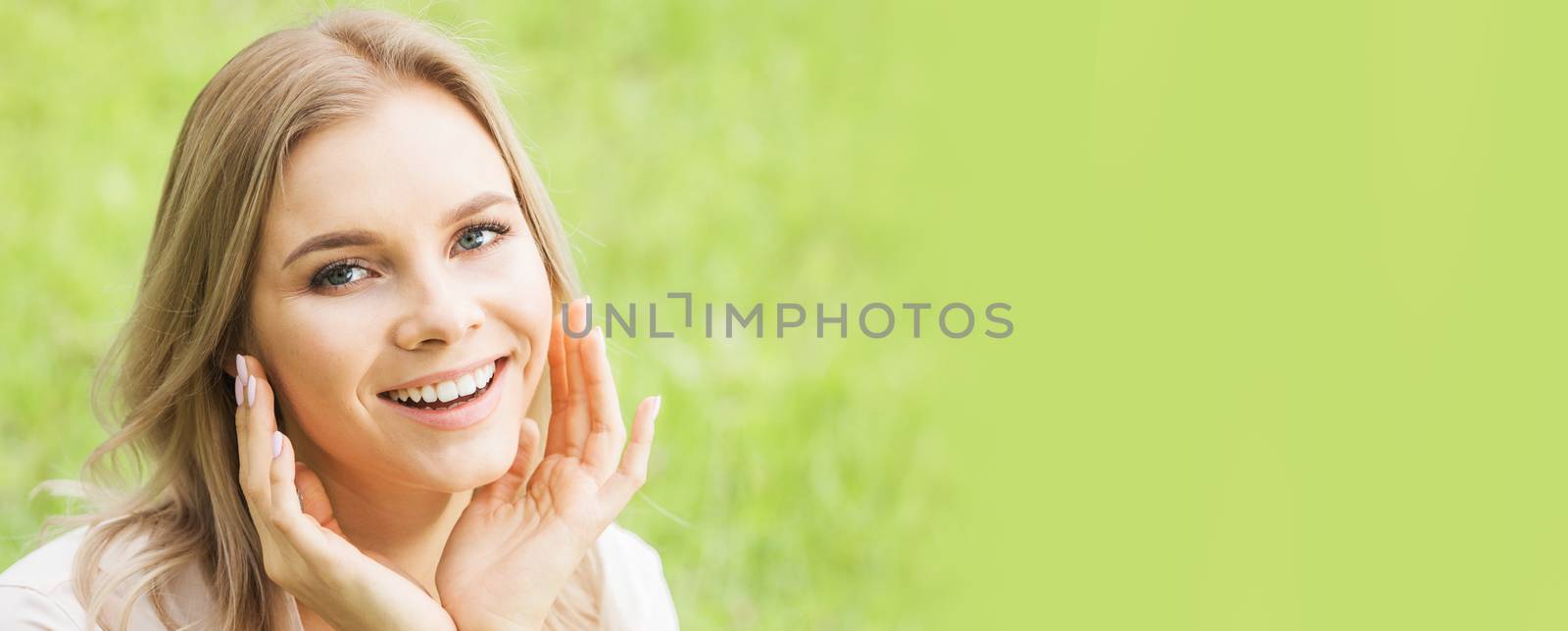 Portrait of a beautiful female model on green grass background, natural beauty