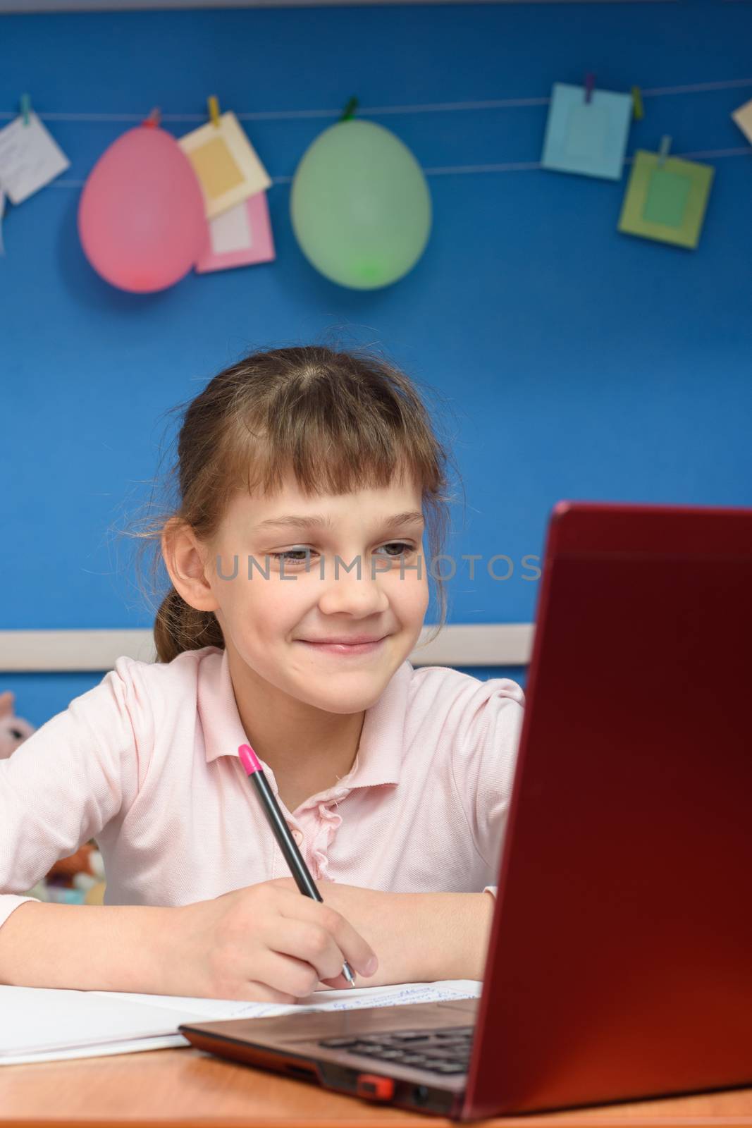 Happy girl studying in quarantine at home online