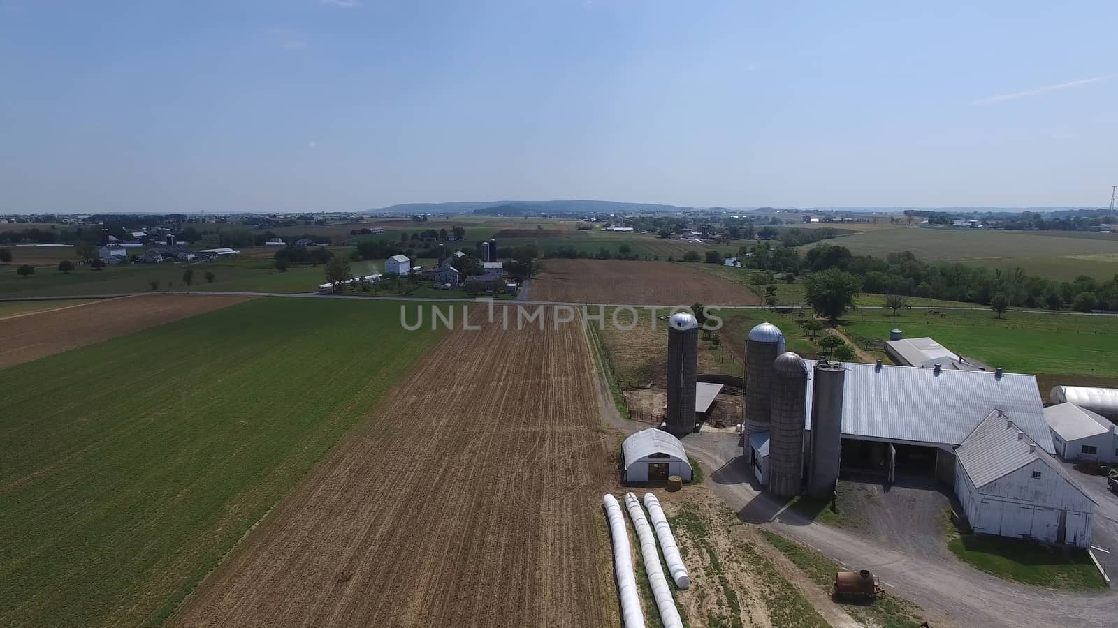 Aerial View of Amish Farm Countryside in Autumn from a Drone