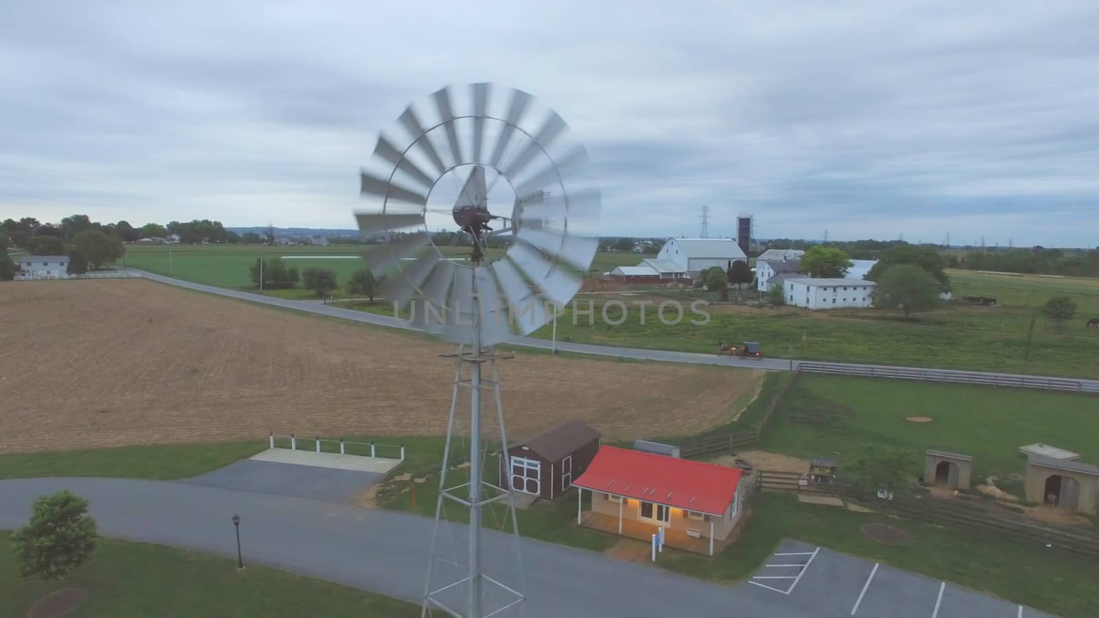 Aerial View of an Amish Windmill as Seen by a Drone on a Cloudy Spring Day