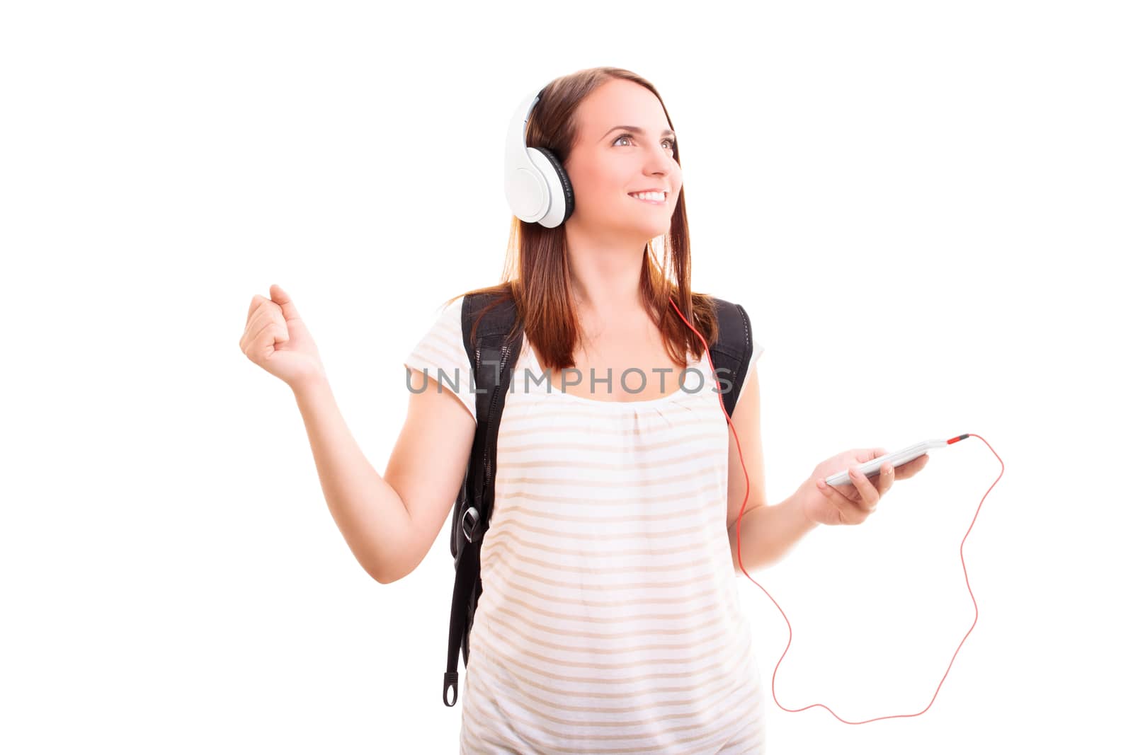 Beautiful smiling blond young girl with headphones listening to music, isolated on white background. Music and sound concept.