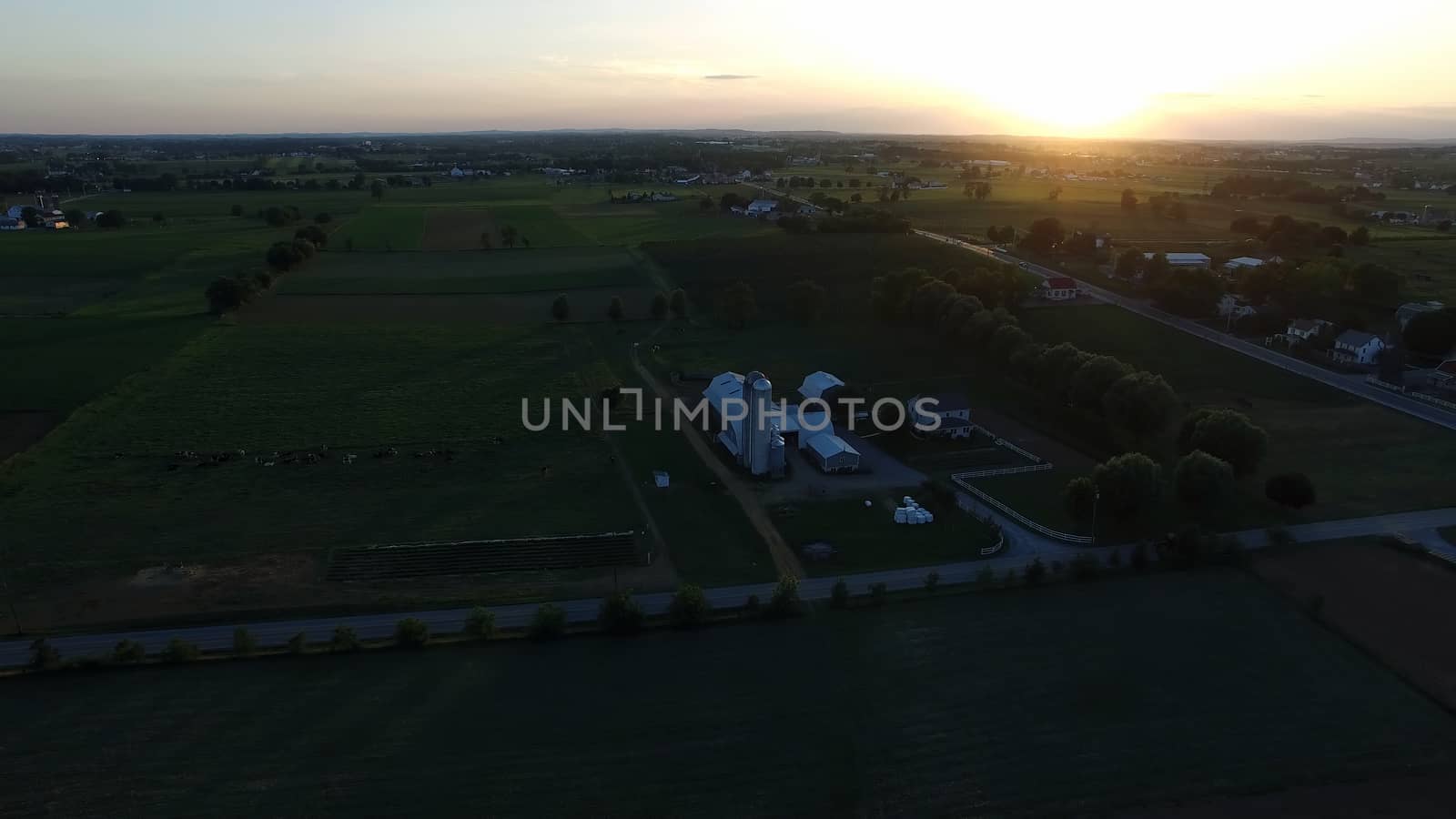 Aerial View of a Sunset on a Summer Day in Amish Countryside as Seen by a Drone