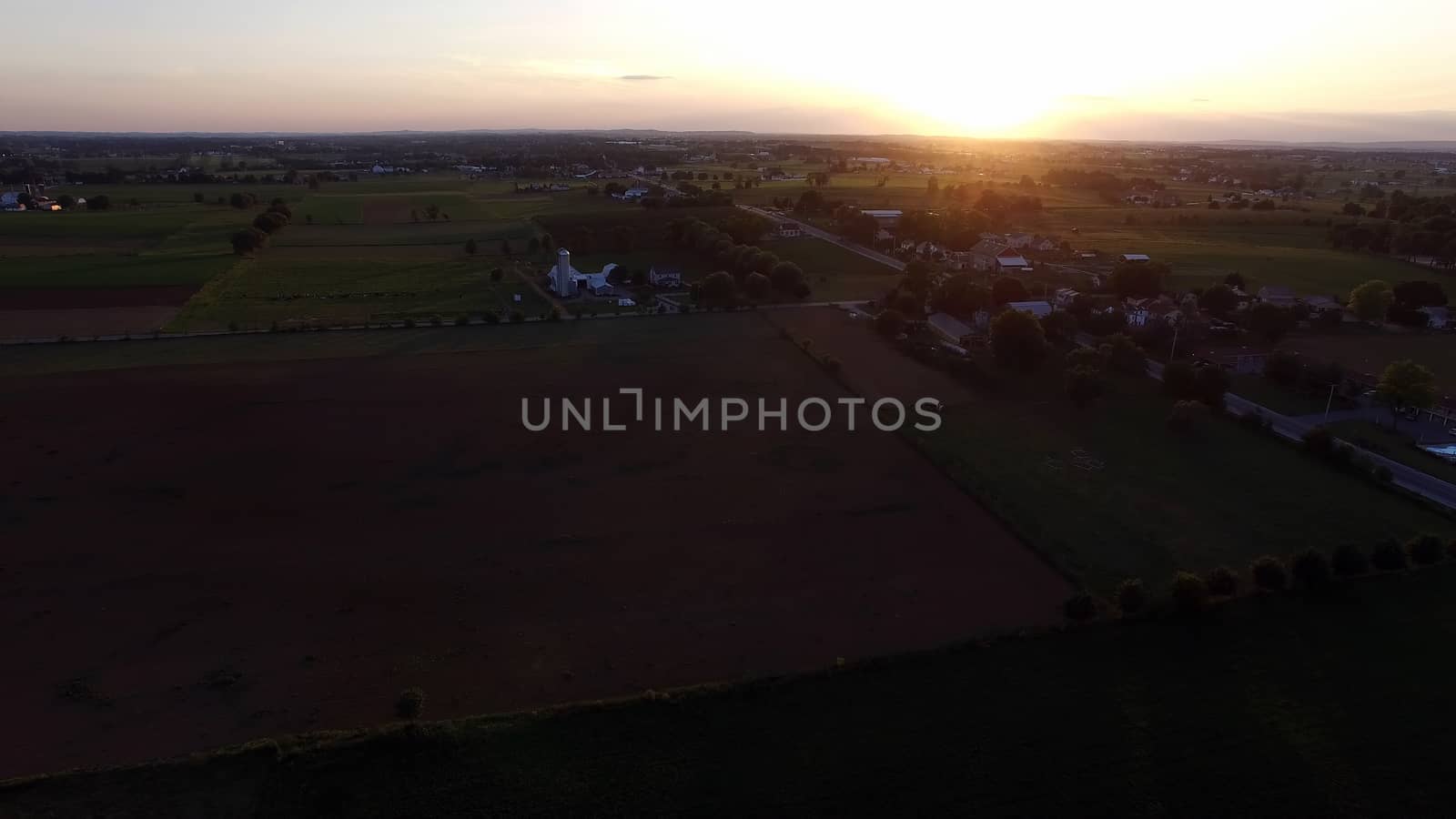 Aerial View of a Sunset on a Summer Day in Amish Countryside as Seen by a Drone