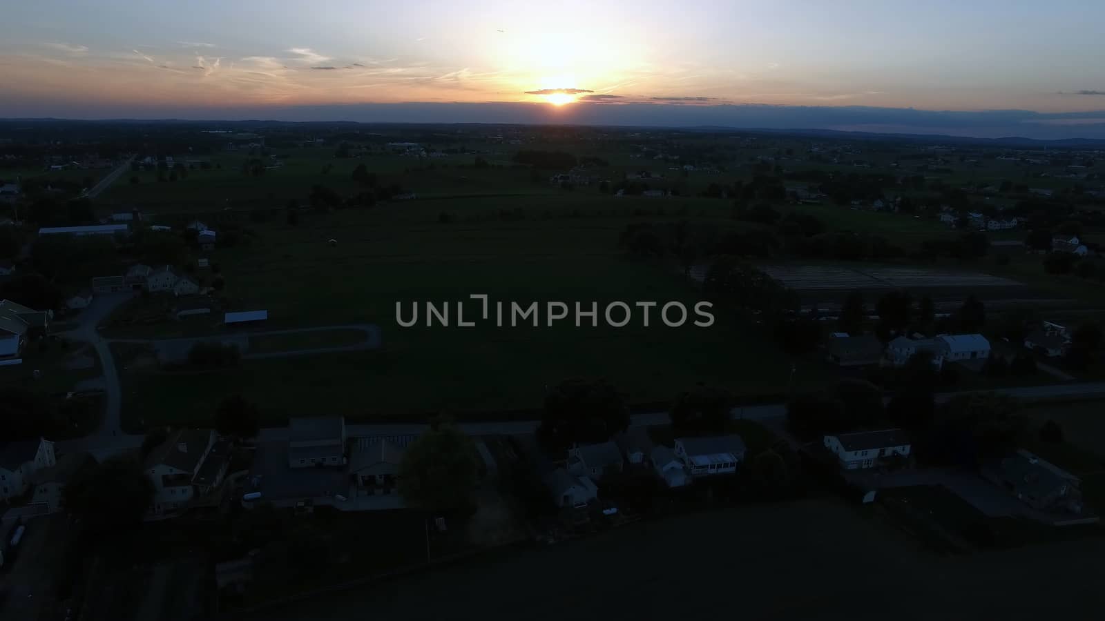 Aerial View of a Sunset on a Summer Day in Amish Countryside as Seen by a Drone