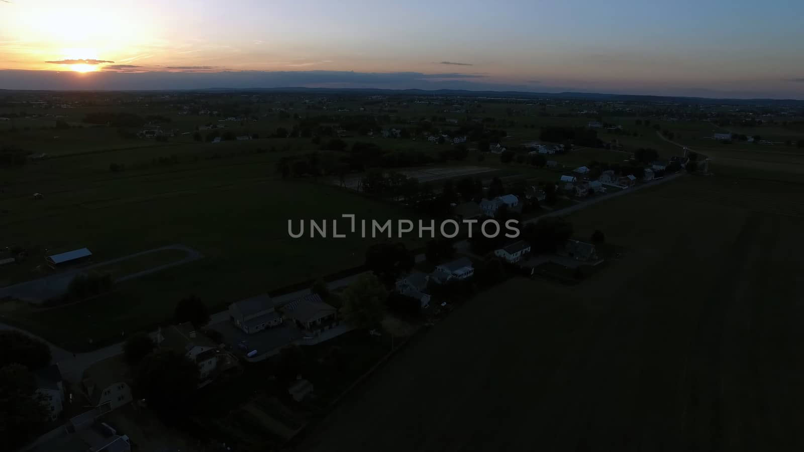 Aerial View of a Sunset on a Summer Day in Amish Countryside as Seen by a Drone