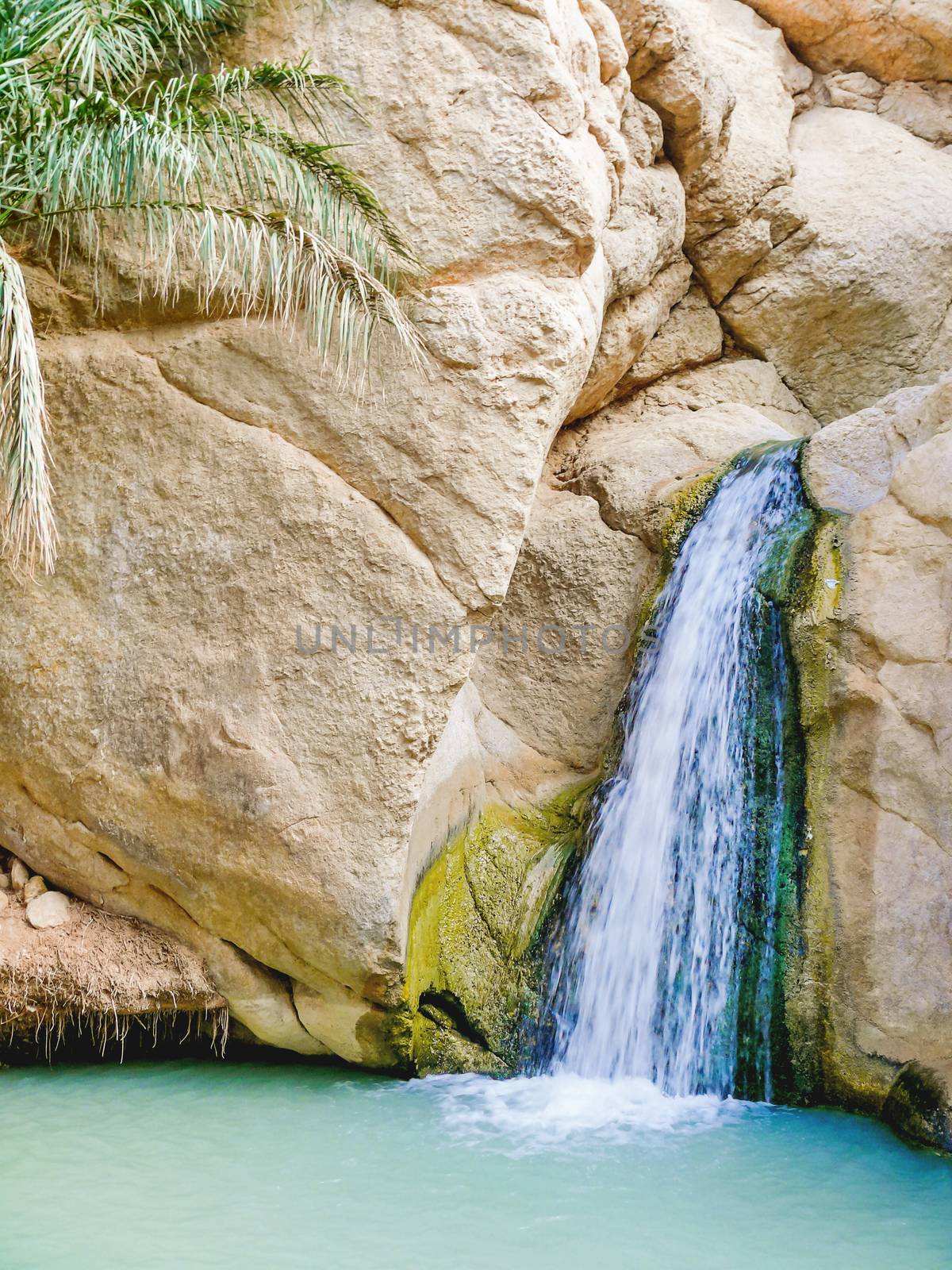 Waterfall among the rocks of oasis Chebika, famous landmark in Sahara desert.