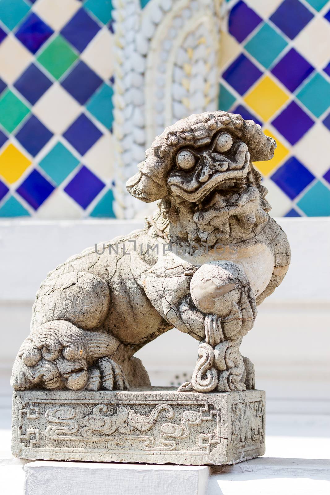 Buddhist sculpture. Chinese guardian lion statue in Royal Palace, Bangkok, Thailand.