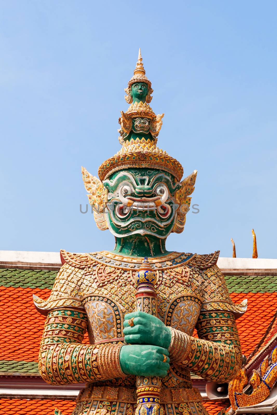 Sculpture in Royal Palace, Bangkok, Thailand. Wat Phra Keo. Architecture detail - statue of mythical creature with green skin. by aksenovko