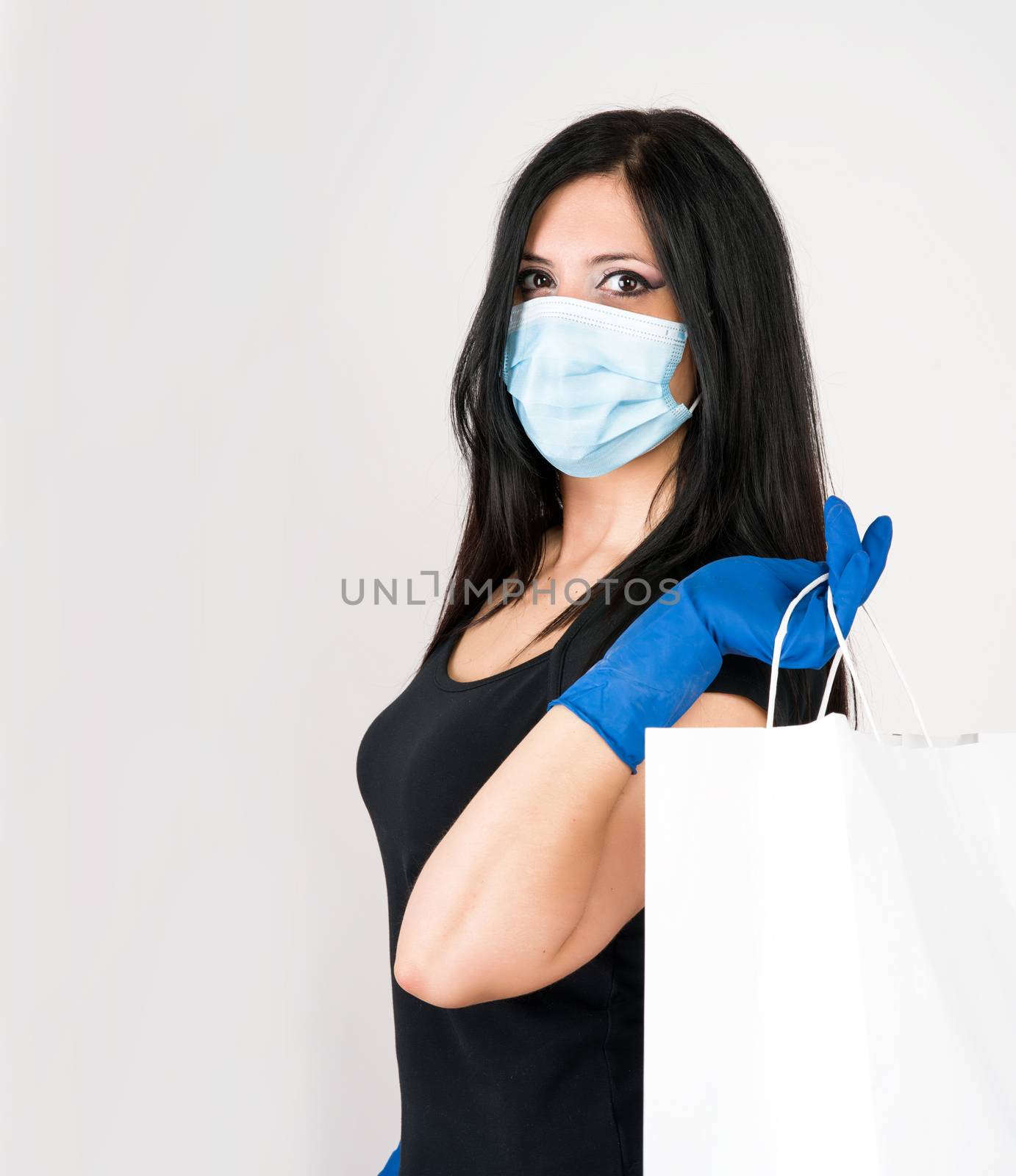 beautiful woman recommends what to wear for prevention, gloves and mask with shopping bag. isolated