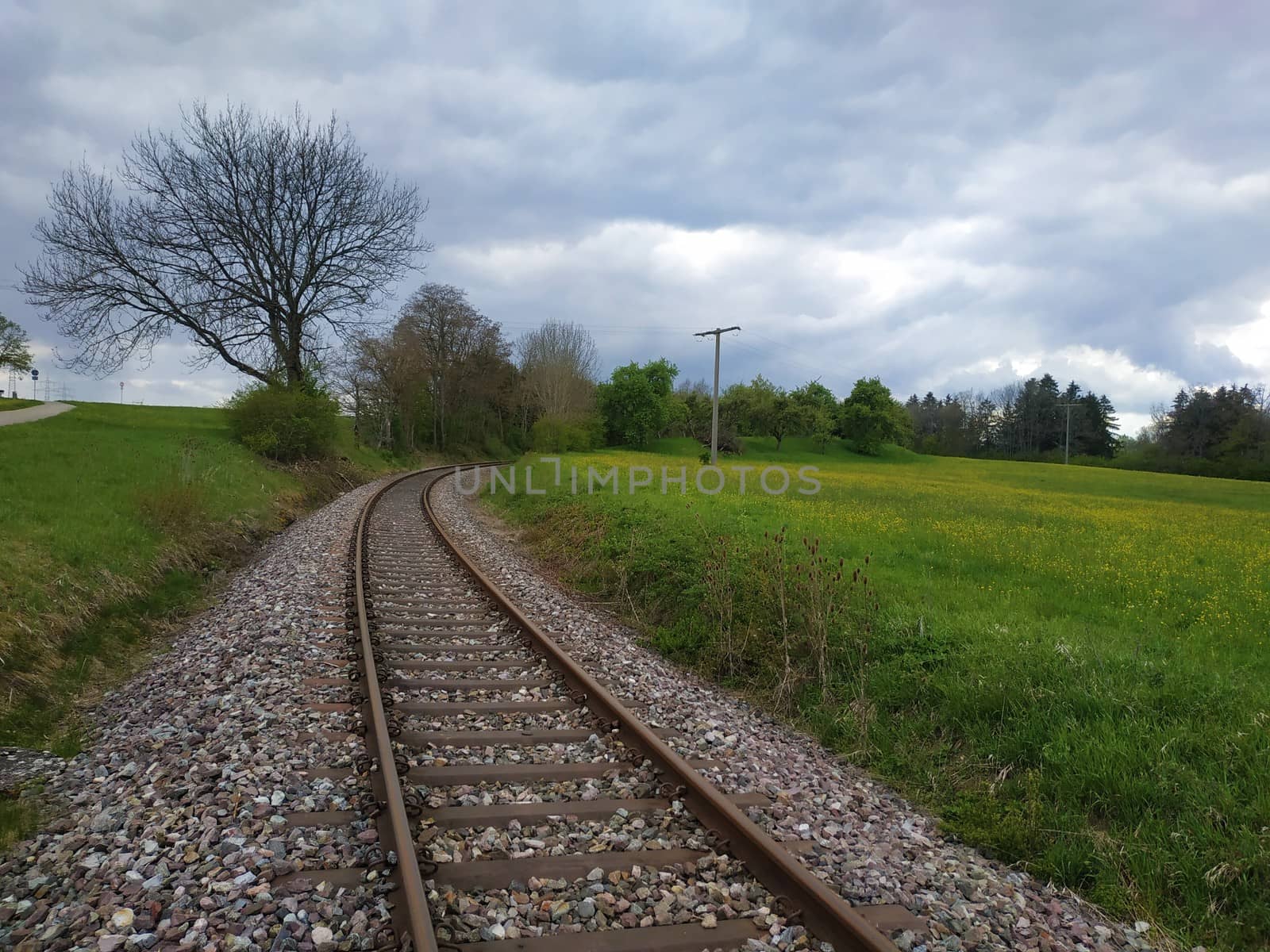 Railway track running through rural landscape in Germany by pisces2386