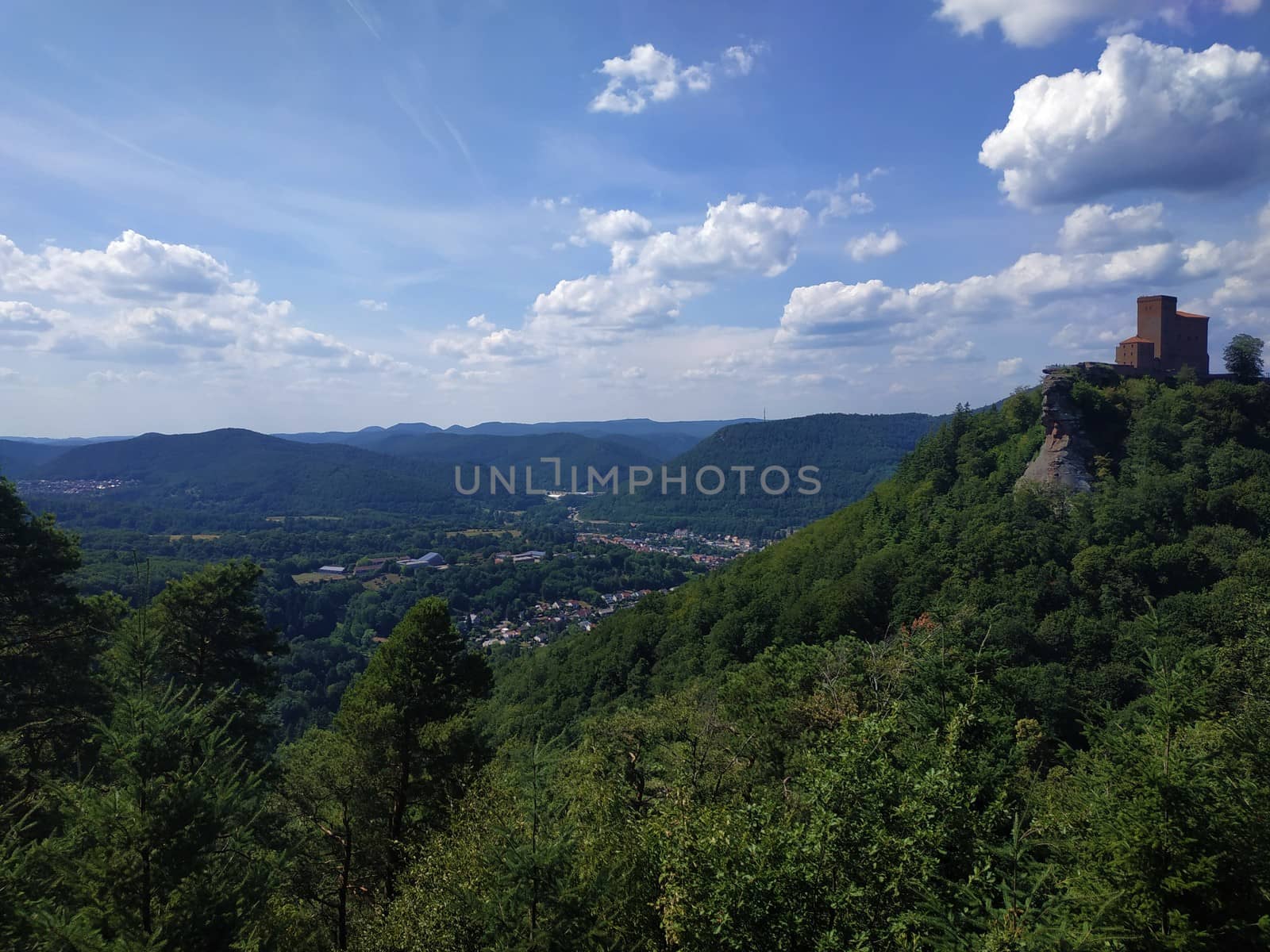 Dramatic landscape with mountains, hills, clouds and blue sky spotte in Germany