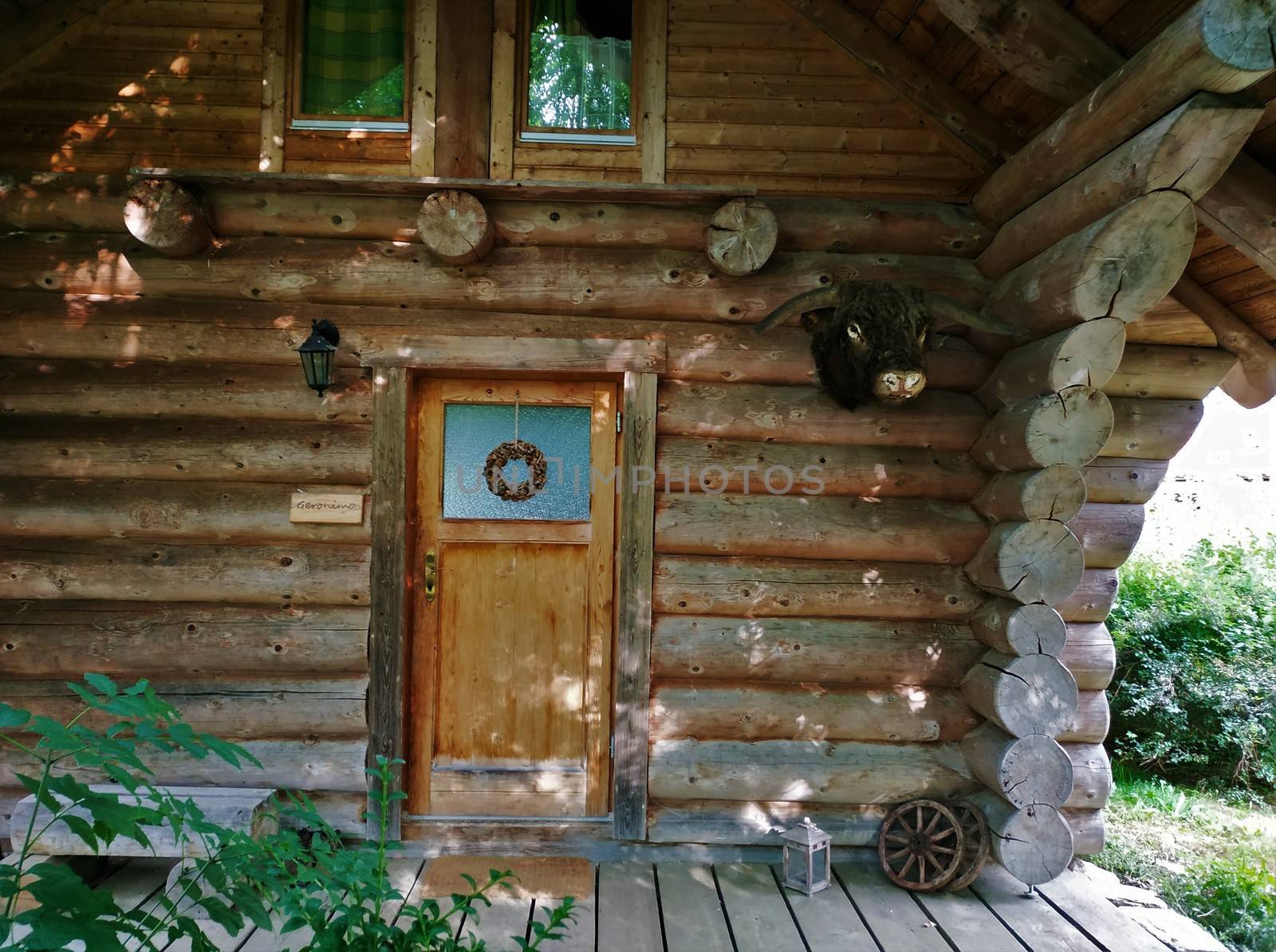 Exterior view on wooden house with trophy head on the wall