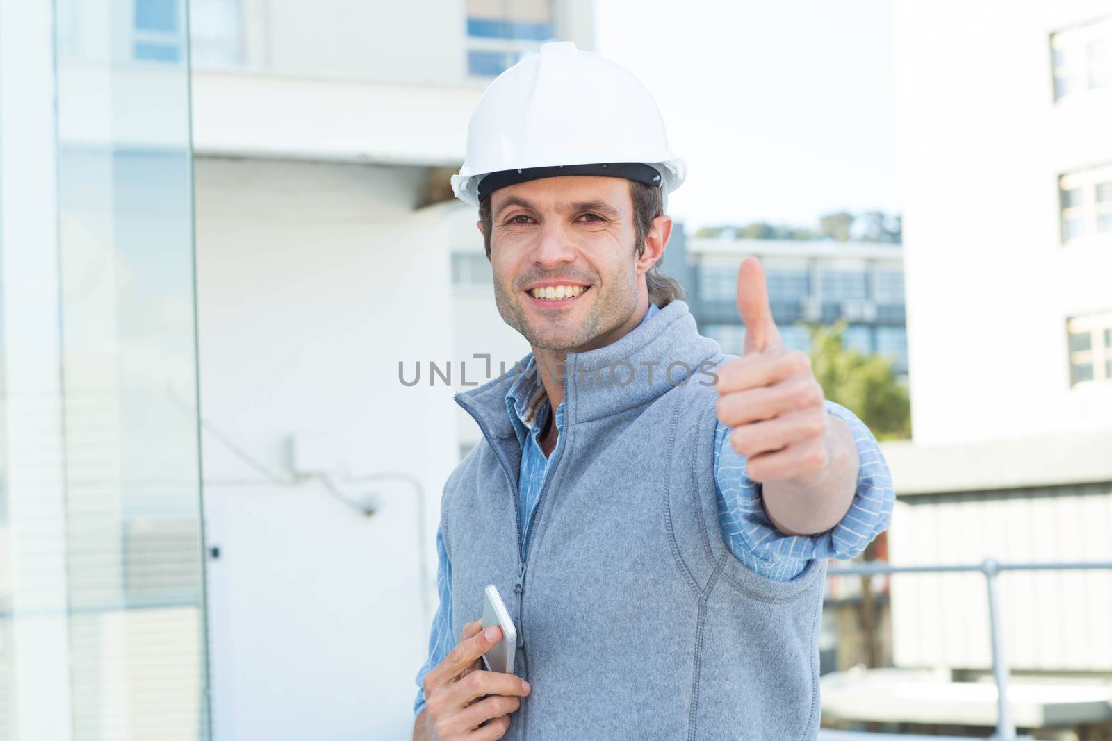 Handsome male architect gesturing thumbs up by Wavebreakmedia