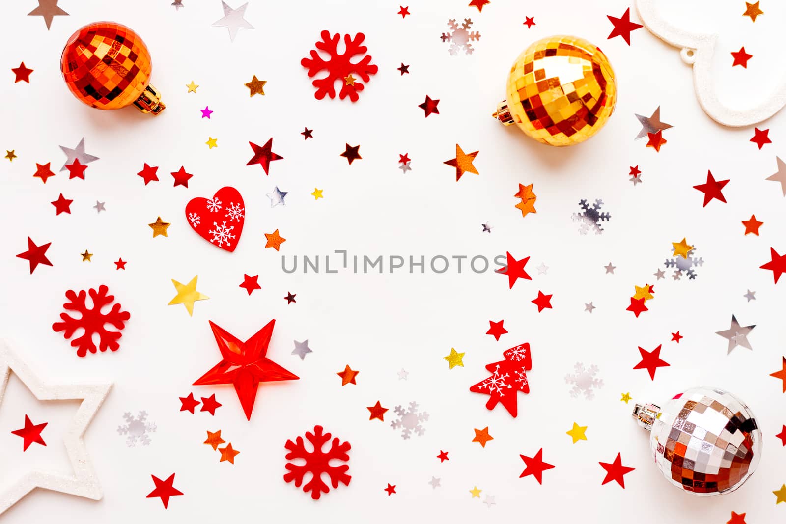 Christmas and New Year holiday background with decorations and clear round background in center. Shiny balls, felt snowflakes and star confetti. Flat lay, top view.