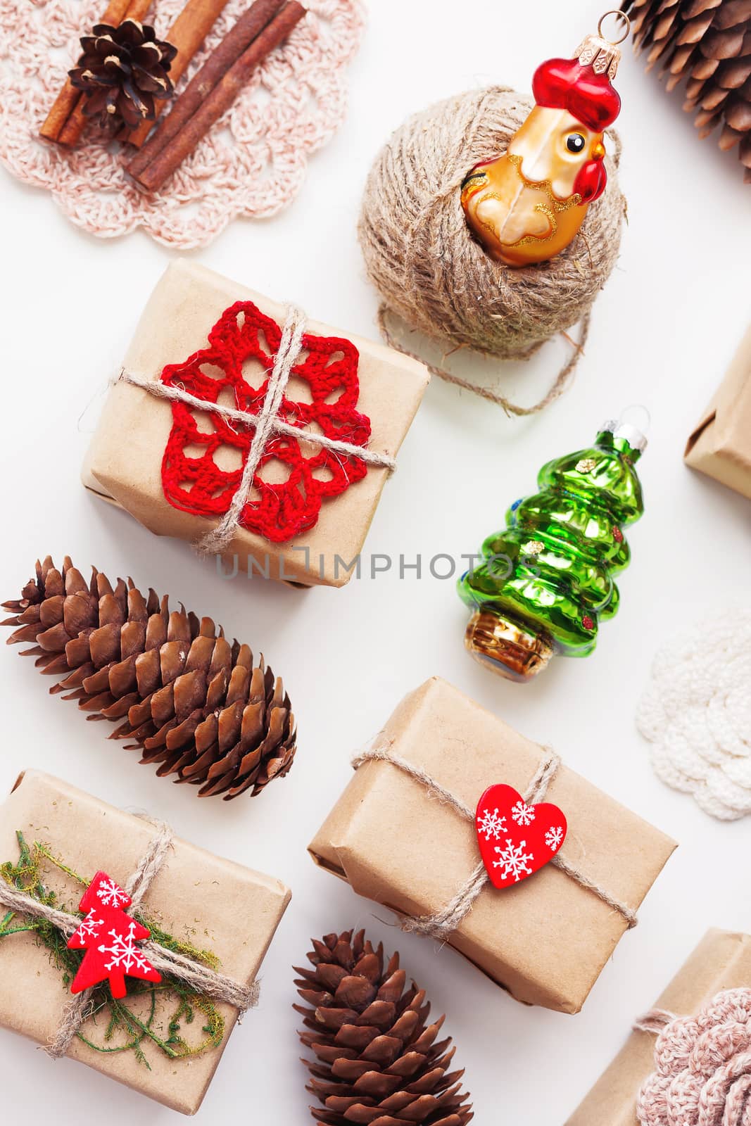 Christmas and New Year background with handmade presents wrapped in craft paper and decorations, holiday symbols.