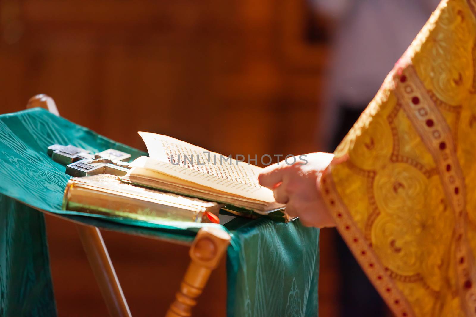 Prayer book in the hands of the priest. Ceremony in the Orthodox Christian Church. Russia. Selective focus.