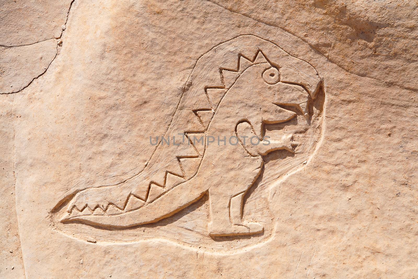 Funny dinosaur carved into the rock near St Julian's, Malta.