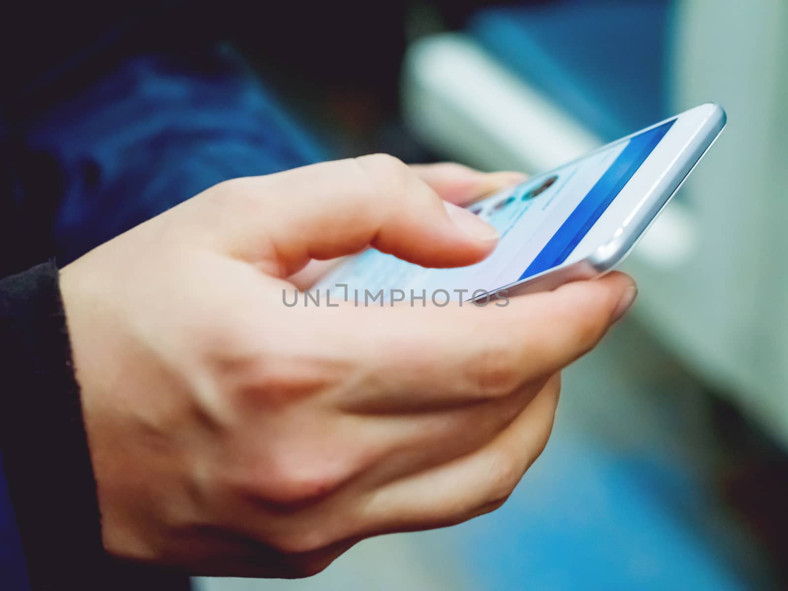 Man holds a smartphone in hand.
