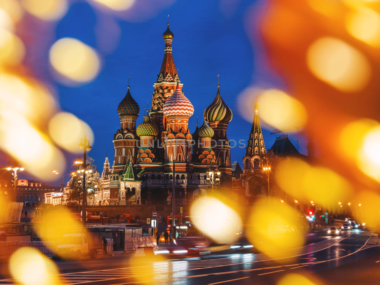 Famous landmark - St. Basil Cathedral on Red square in Kremlin. Light bulbs bokeh. Moscow, Russia.
