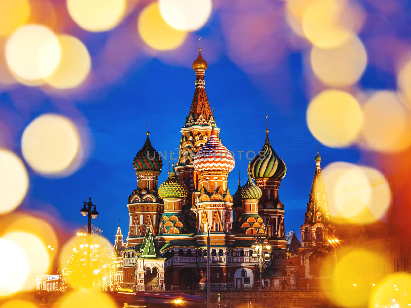 Famous landmark - St. Basil Cathedral on Red square in Kremlin. Light bulbs bokeh. Moscow, Russia.