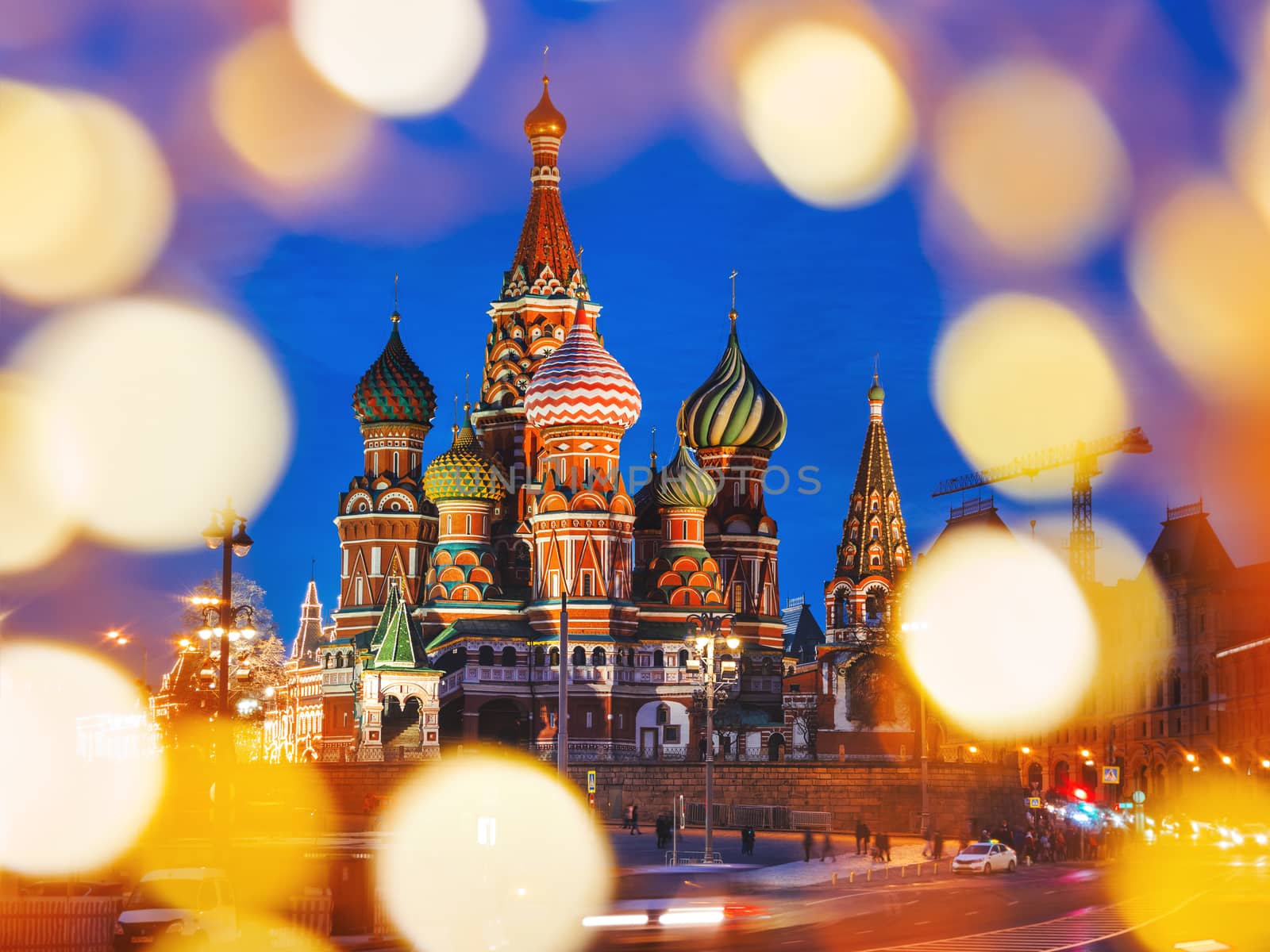 Famous landmark - St. Basil Cathedral on Red square in Kremlin. Light bulbs bokeh. Moscow, Russia.