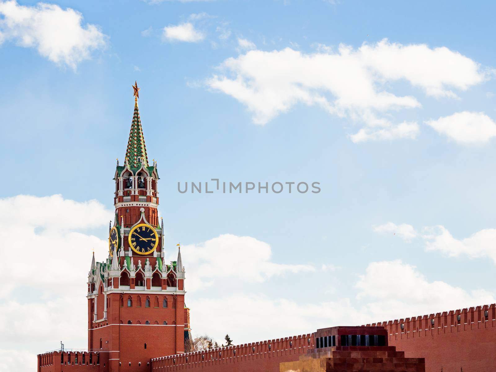 Famous Spasskaya tower with Kremlin chimes and red star on top. Historic landmark on Red Square in Moscow, Russia.