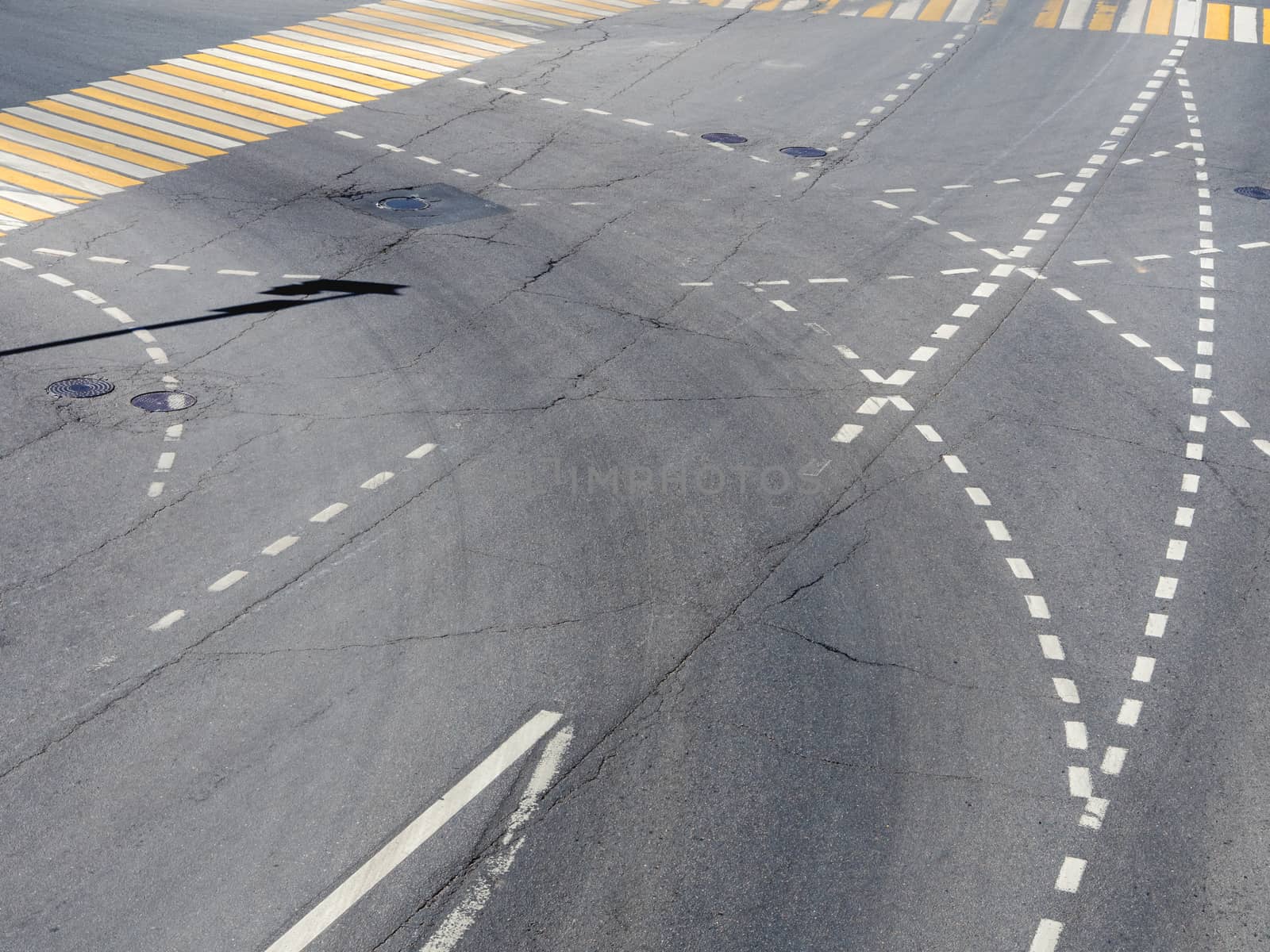 Road markings on the asphalt. Painted signs on the roadway and pedestrian crosswalk. Dotted line and arrows. Moscow, Russia.