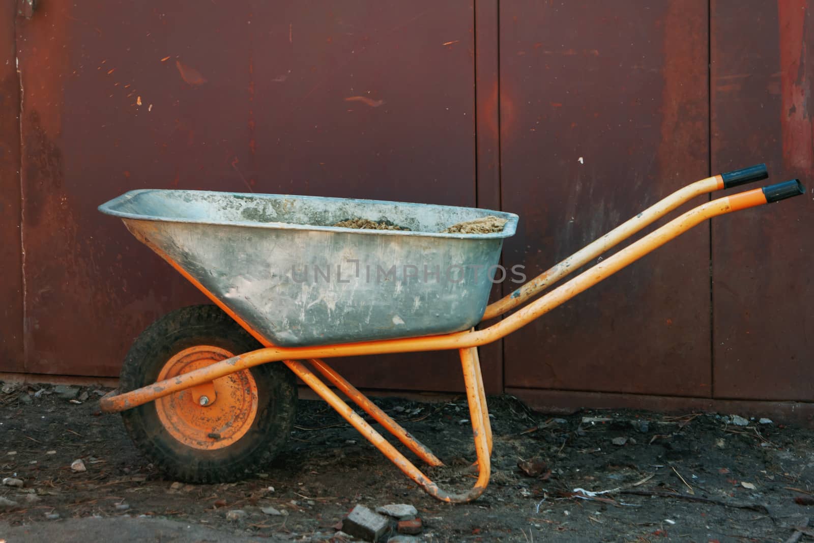 Cart for garbage removal stands at the construction site.