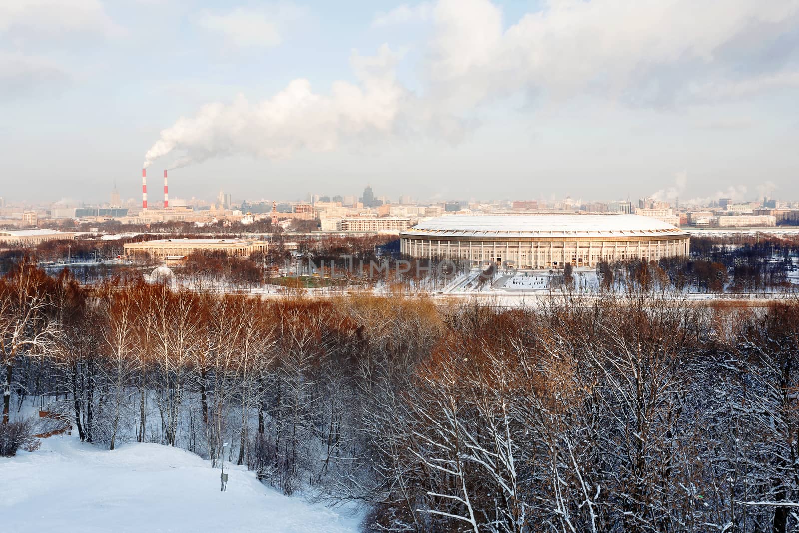 Panorama view on Luzhniki stadium and Sparrow Hills from observation deck near Moscow State Univercity (MSU). Aerial cityscape in winter sunny day. Moscow, Russia.