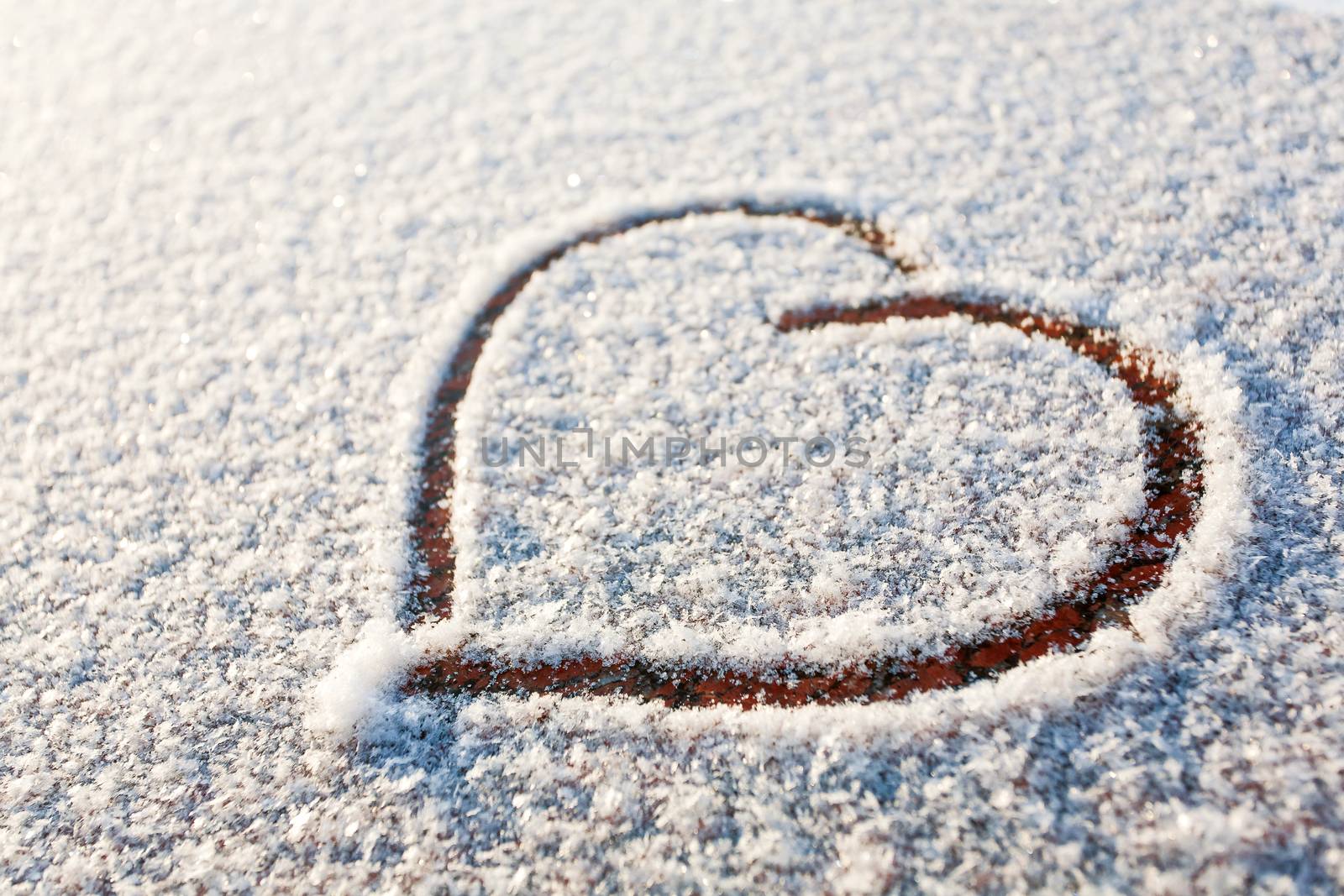 Heart drawn in snow. Symbol of love.