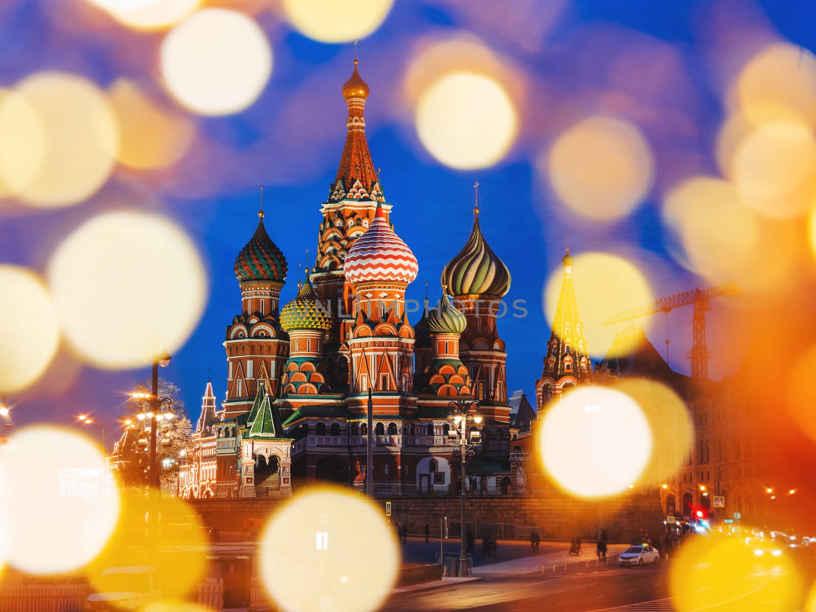 Famous landmark - St. Basil Cathedral on Red square in Kremlin. Light bulbs bokeh. Moscow, Russia.