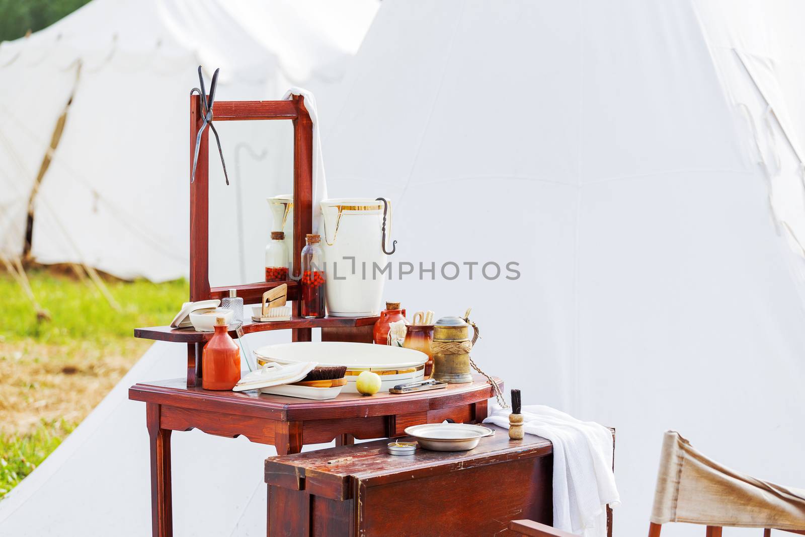 Old fashioned barber portable set - mirror, rowan tincture, razor, shaving brush, jar with water, nippers for moustaches, oil and ointments. Historical reconstruction of 19th century.