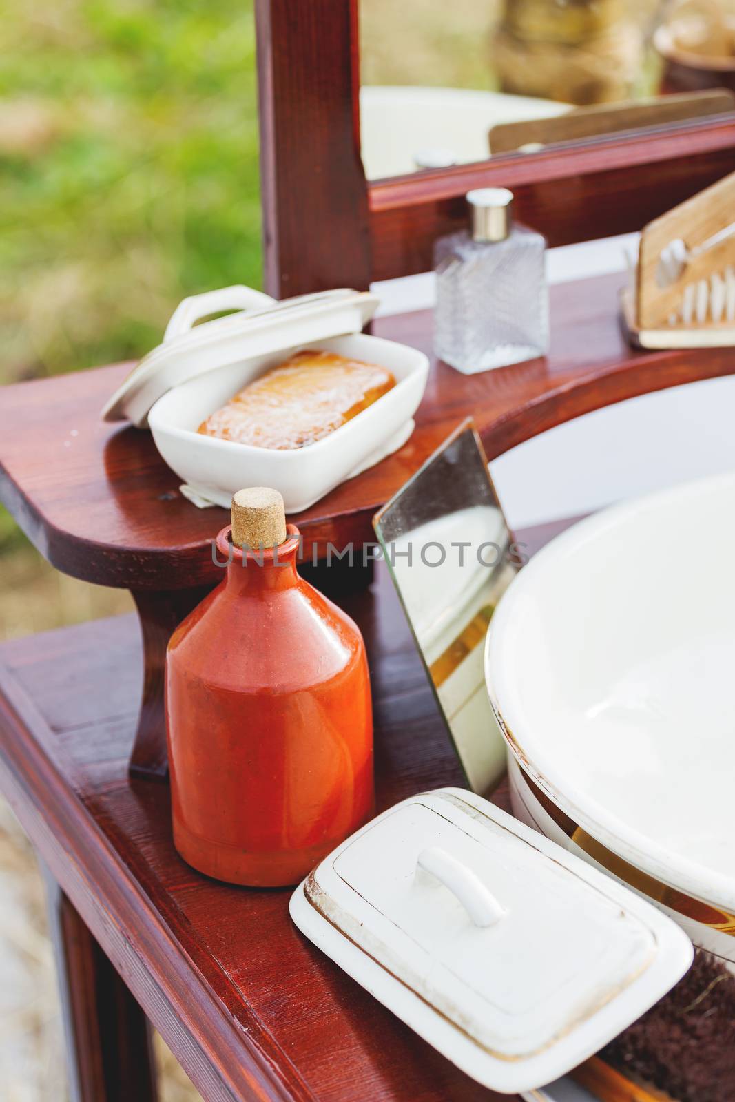 Old fashioned barber portable set - mirror, rowan tincture, razor, shaving brush, jar with water, nippers for moustaches, oil and ointments. Historical reconstruction of 19th century.