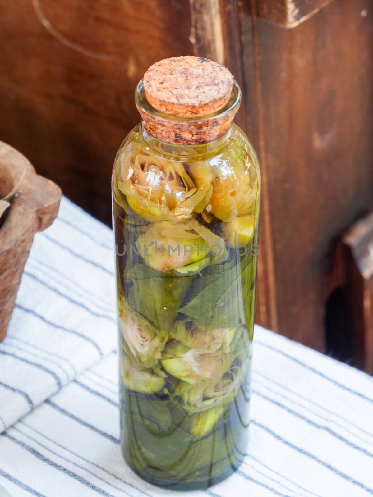 Old glass bottle of rose water. Tincture for barbers with flowers.