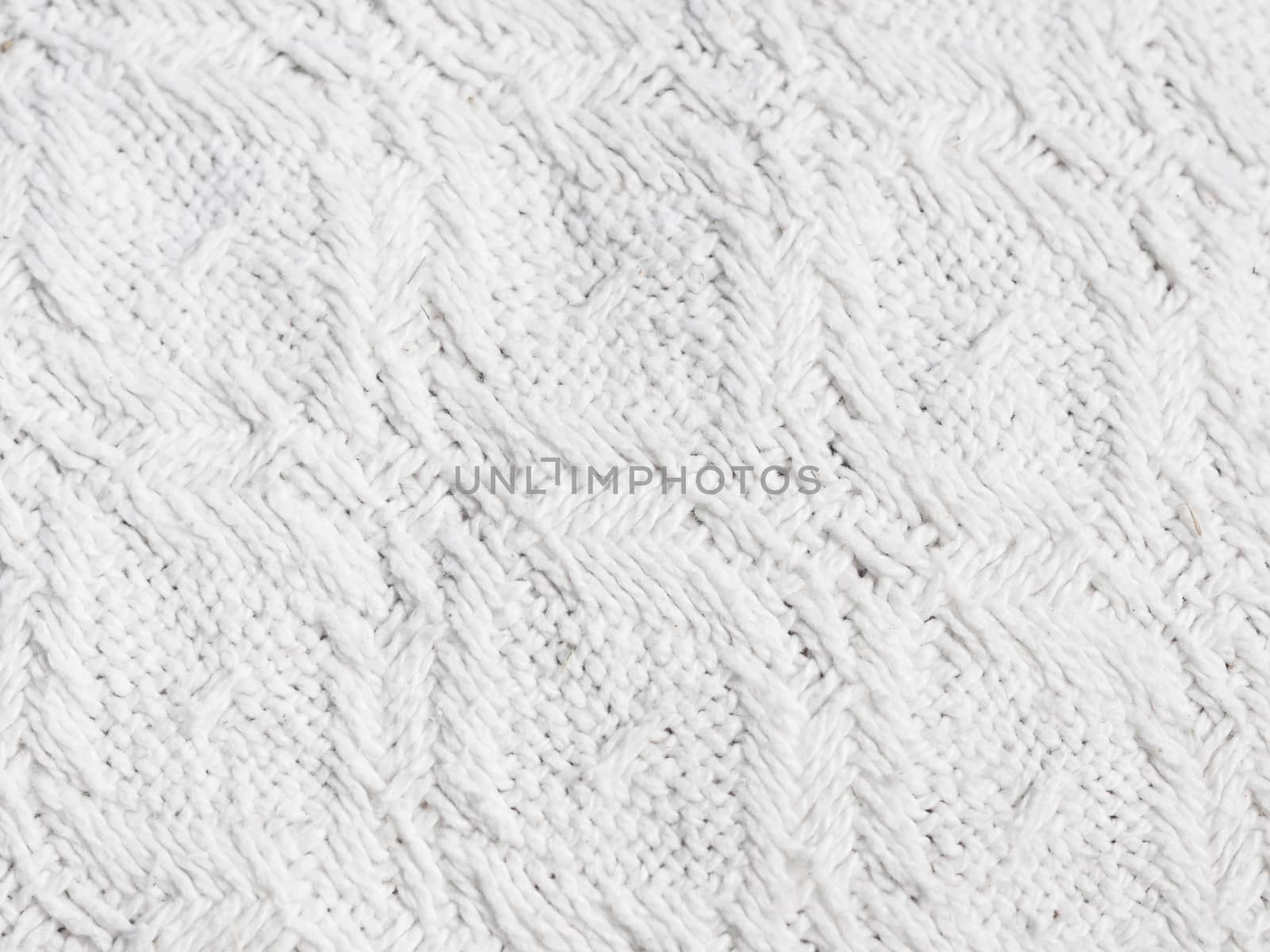 Texture of hand-woven white fabric. Rough threads, prominent textile pattern.