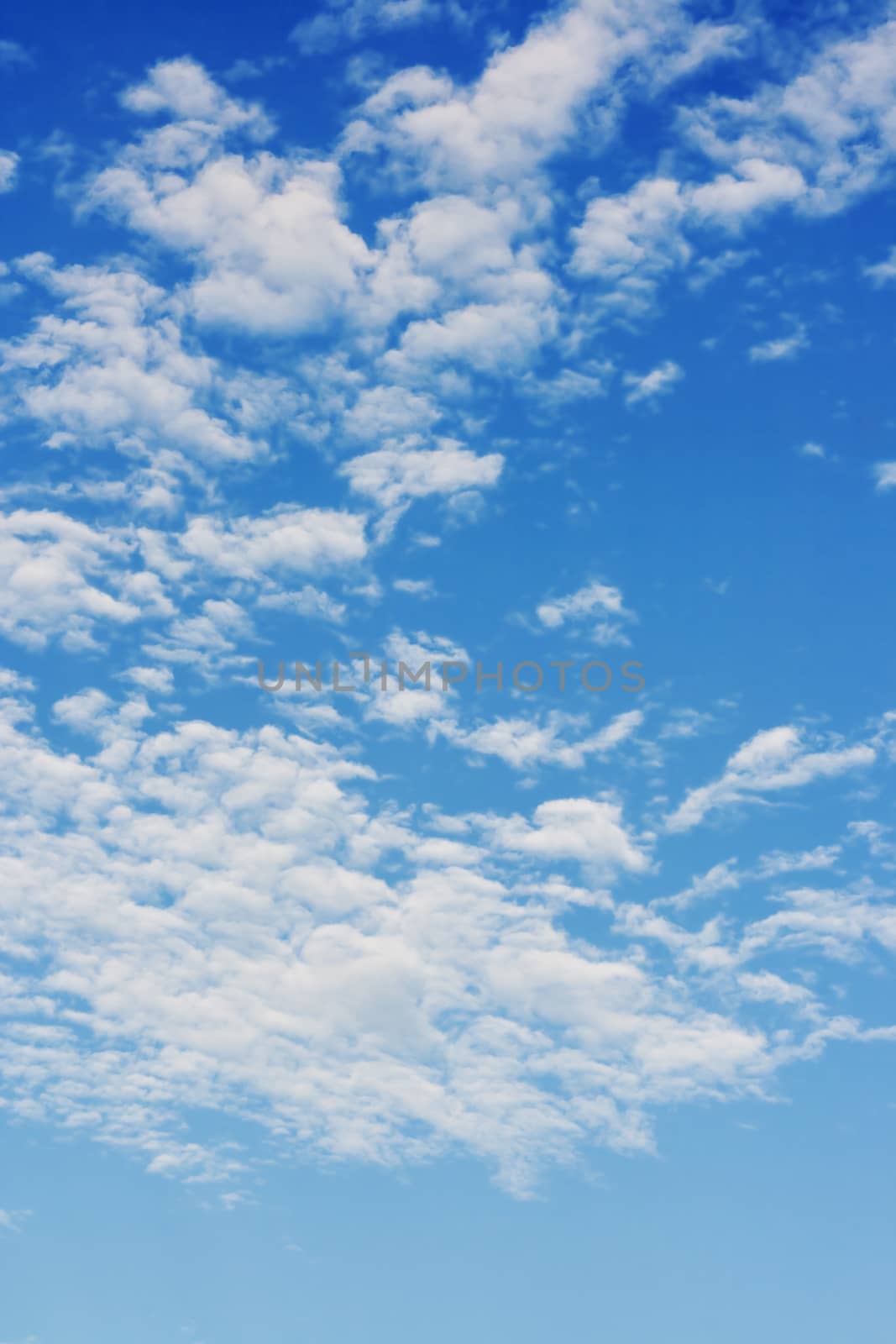 Bright sunny day with clouds. Cloudscape on blue sky. Soft focus. by aksenovko