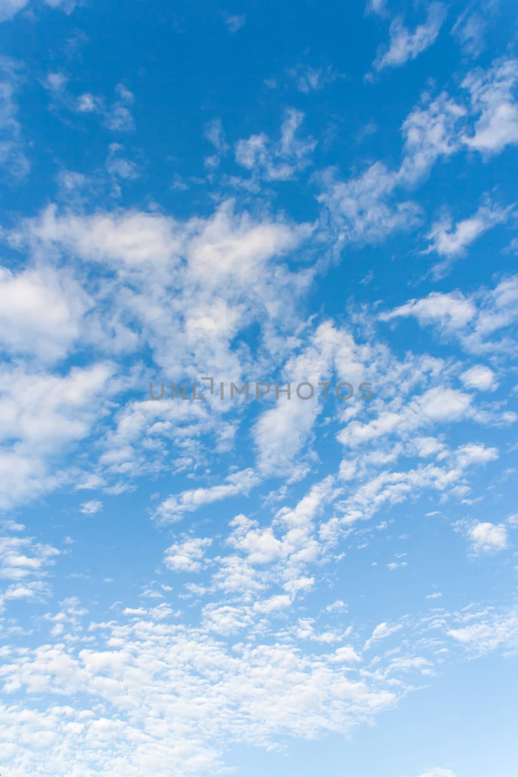 Bright sunny day with clouds. Cloudscape on blue sky. Soft focus. by aksenovko