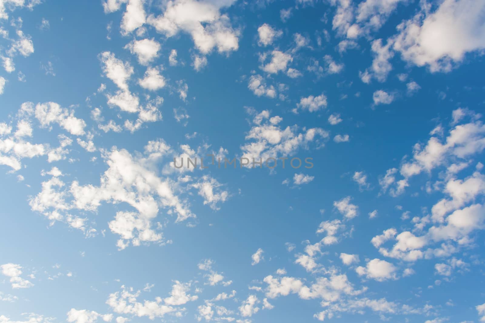 Bright sunny day with clouds. Cloudscape on blue sky. Soft focus.