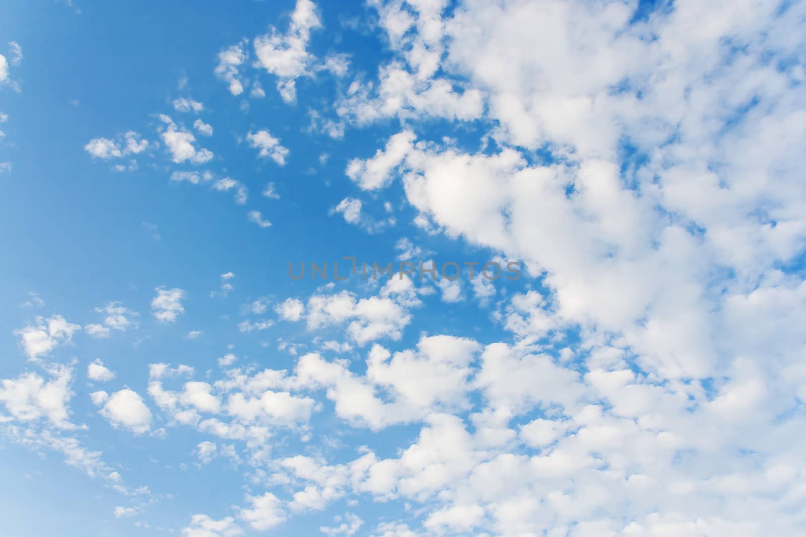 Bright sunny day with clouds. Cloudscape on blue sky. Soft focus.