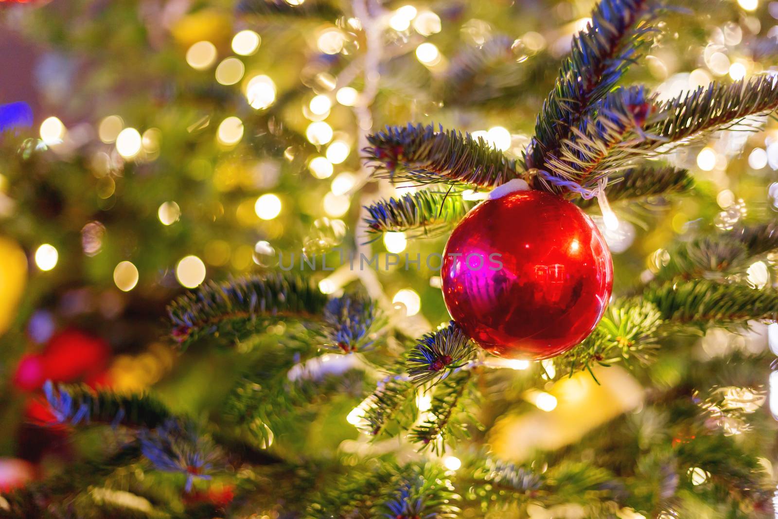 Streets decorated for New Year and Christmas celebration. Tree with bright red and yellow balls. Moscow, Russia.